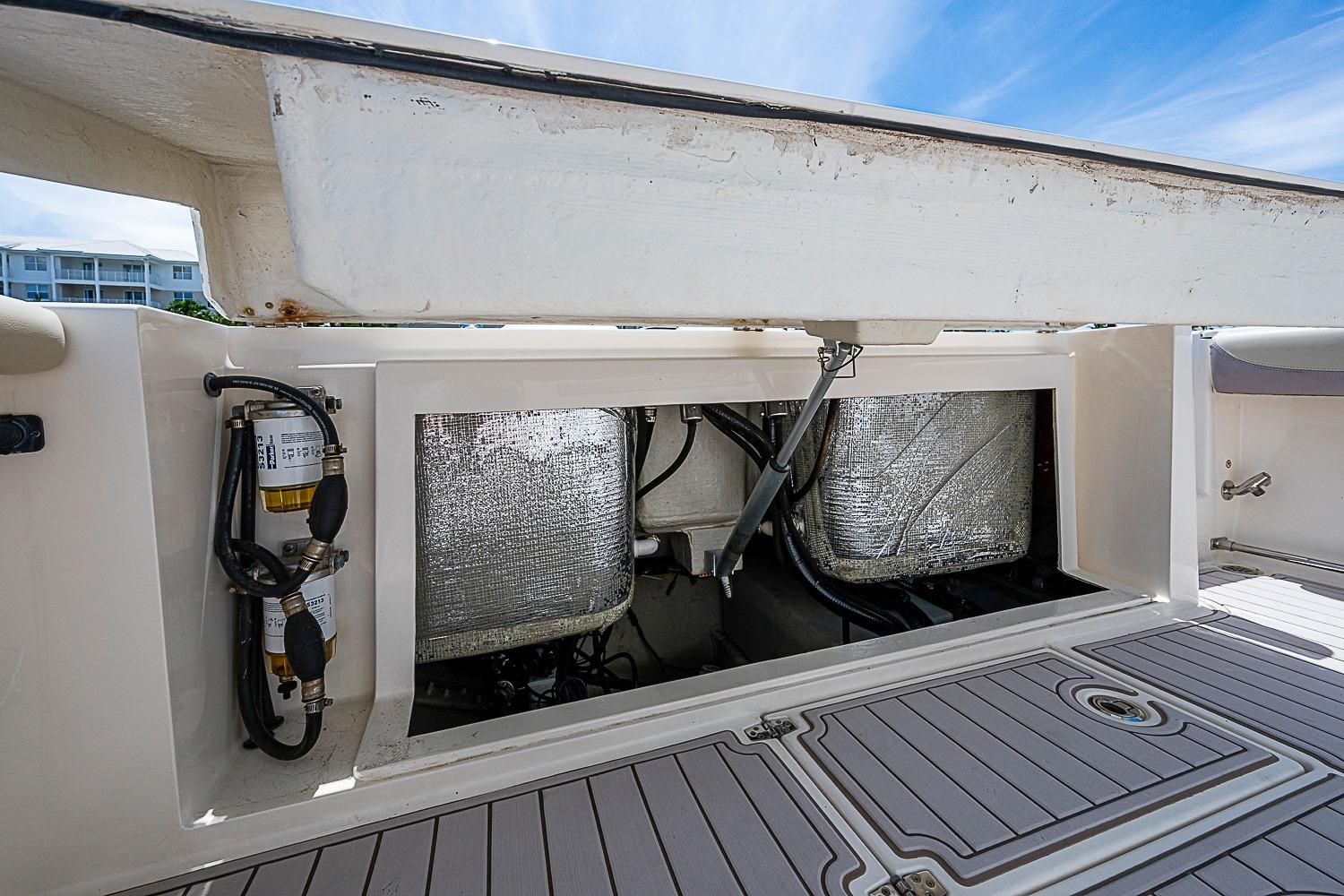2019 Cobia 320 Center Console boat storage compartment with visible wiring and equipment.