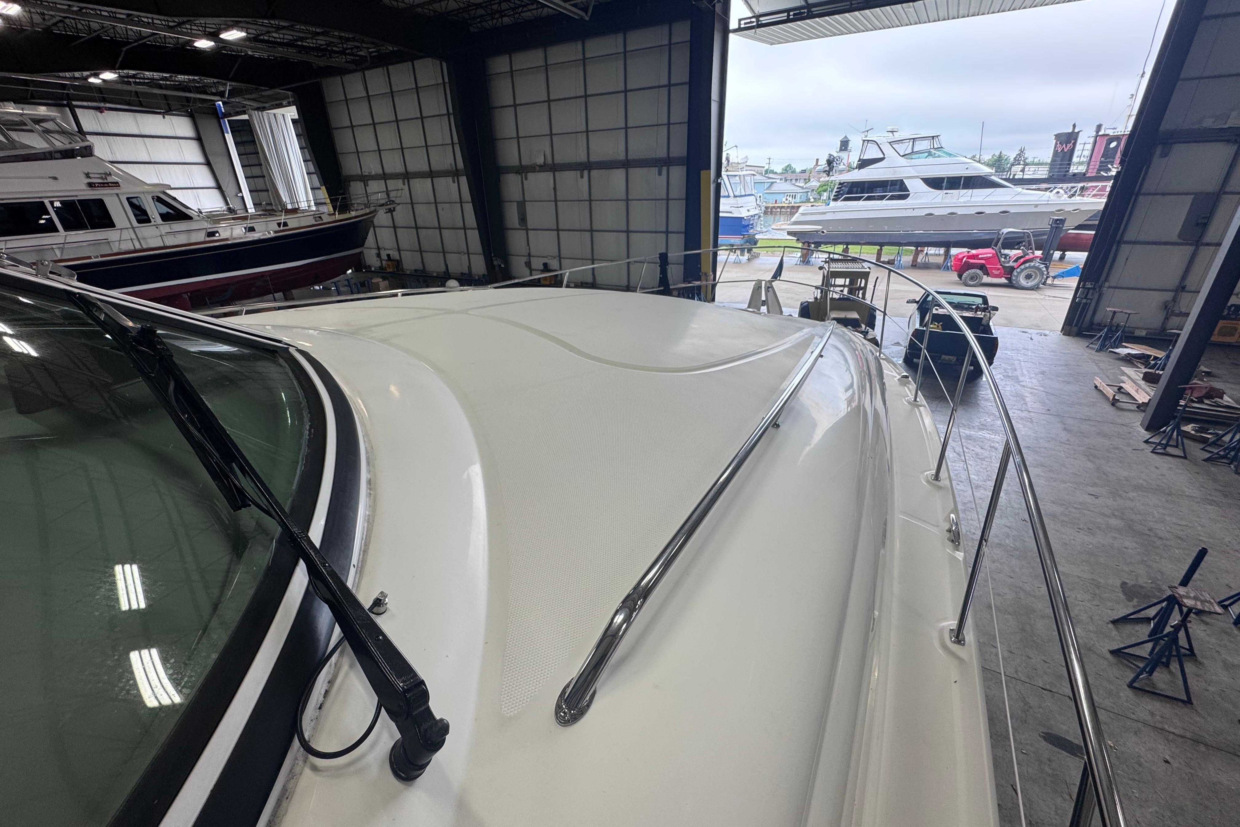 2004 Sea Ray 390 Motor Yacht in a boatyard, surrounded by other vessels.