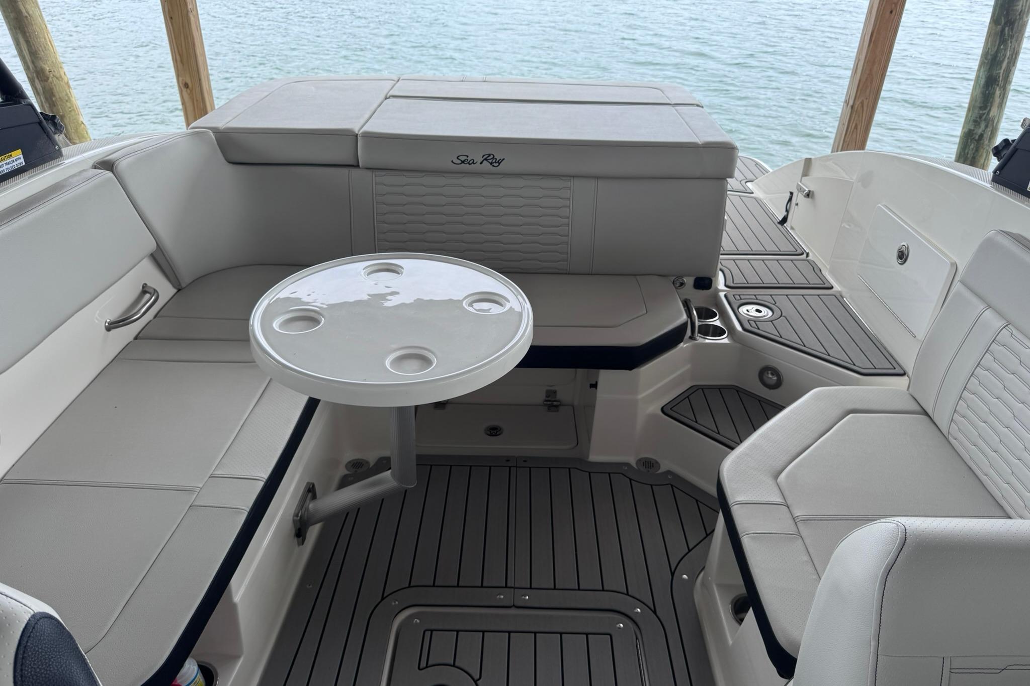 Interior of a 2021 Sea Ray SPX 230 boat with seating and table.