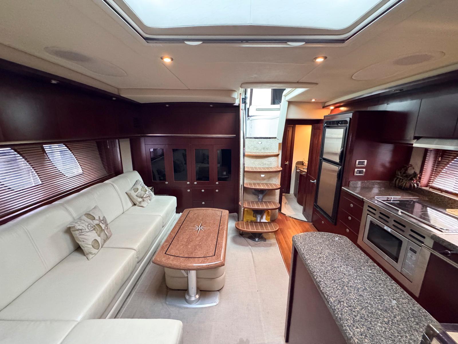 Luxurious interior of 2006 Sea Ray 48 Sundancer yacht with modern kitchen and seating area.