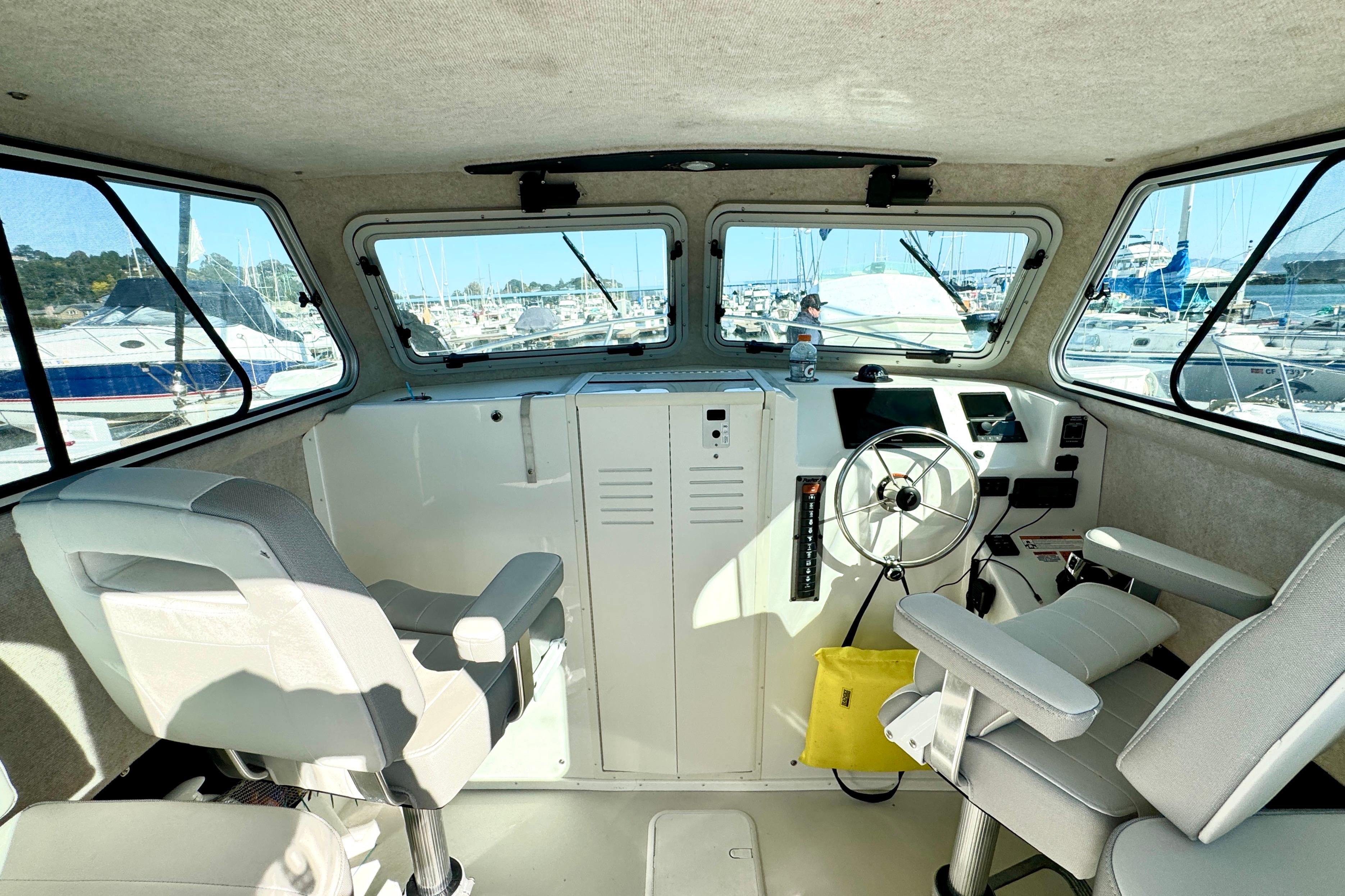 Interior of 2021 Parker 2820 XLD Sport Cabin boat, featuring helm and seating.