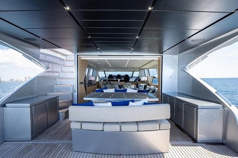 Luxurious 2015 Pershing 92 yacht interior with modern seating and ocean view.