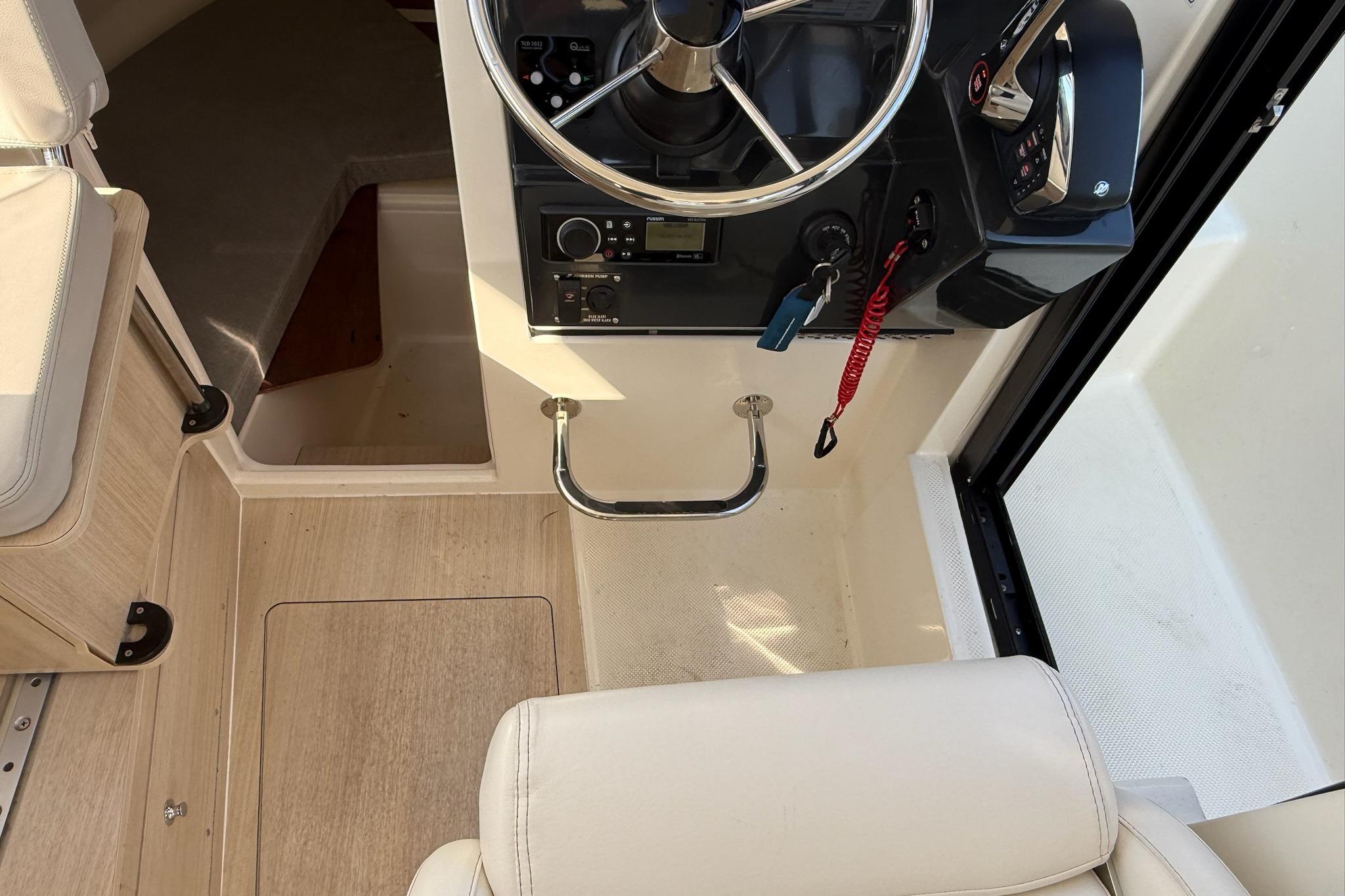2024 Bayliner Trophy T25 Pilothouse helm with steering wheel and controls.