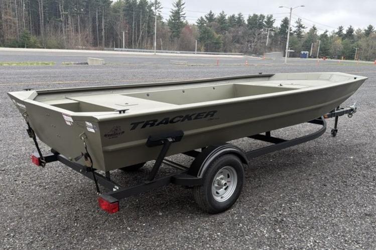 2026 Tracker Grizzly 1754 Utility boat on trailer in parking lot.