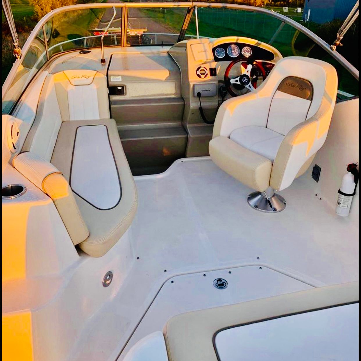 2012 Sea Ray 240 Sundancer boat interior with seating and steering wheel.