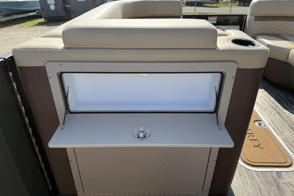 2026 Godfrey Monaco 235 SB boat interior with open storage compartment and cup holder.