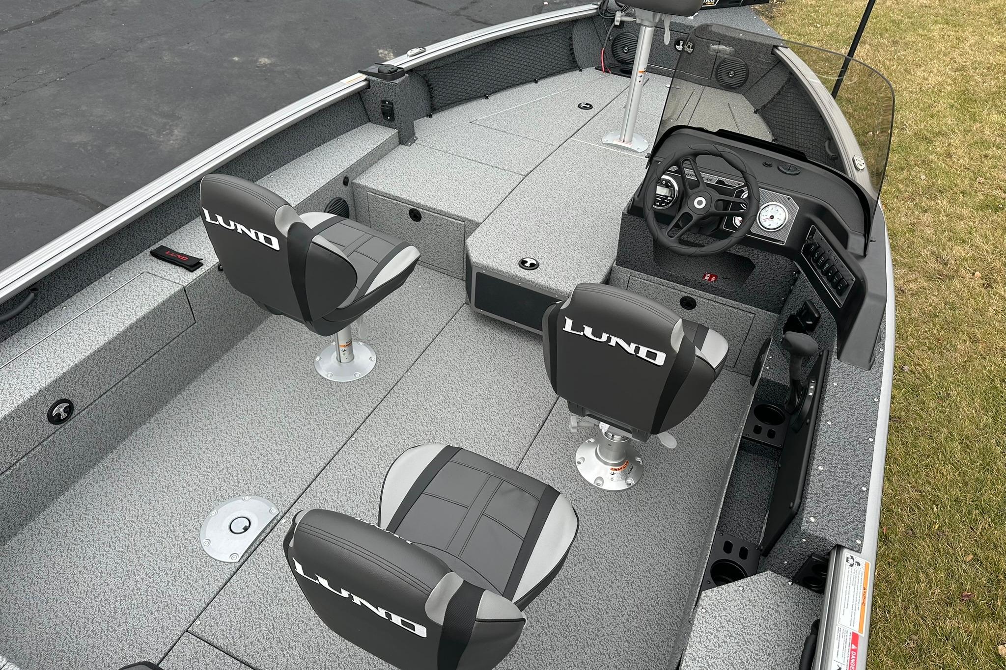 2026 Lund 1875 Impact XS SS boat interior with seating and steering console.