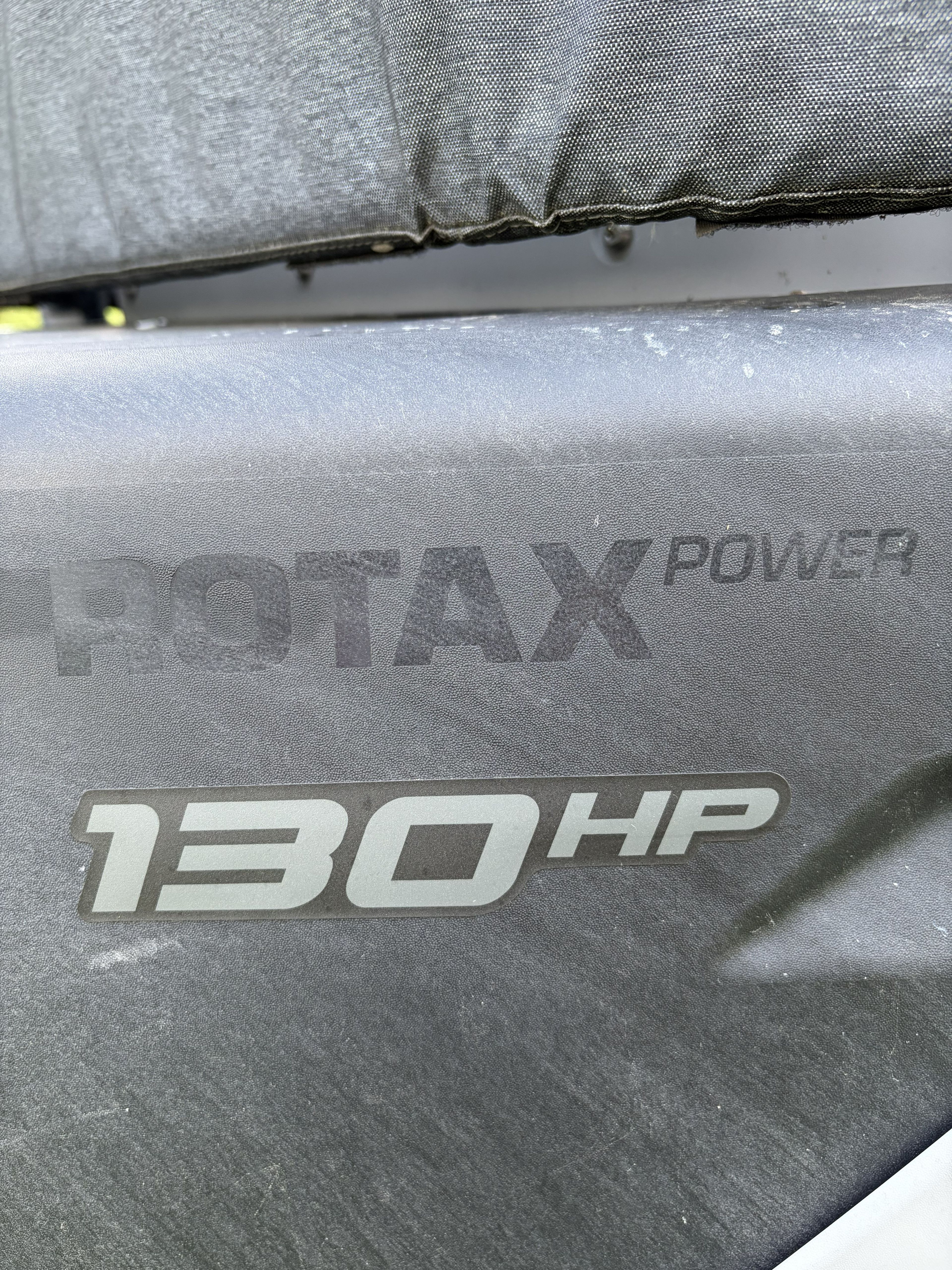 Close-up of "Rotax Power 130 HP" lettering on a boat.