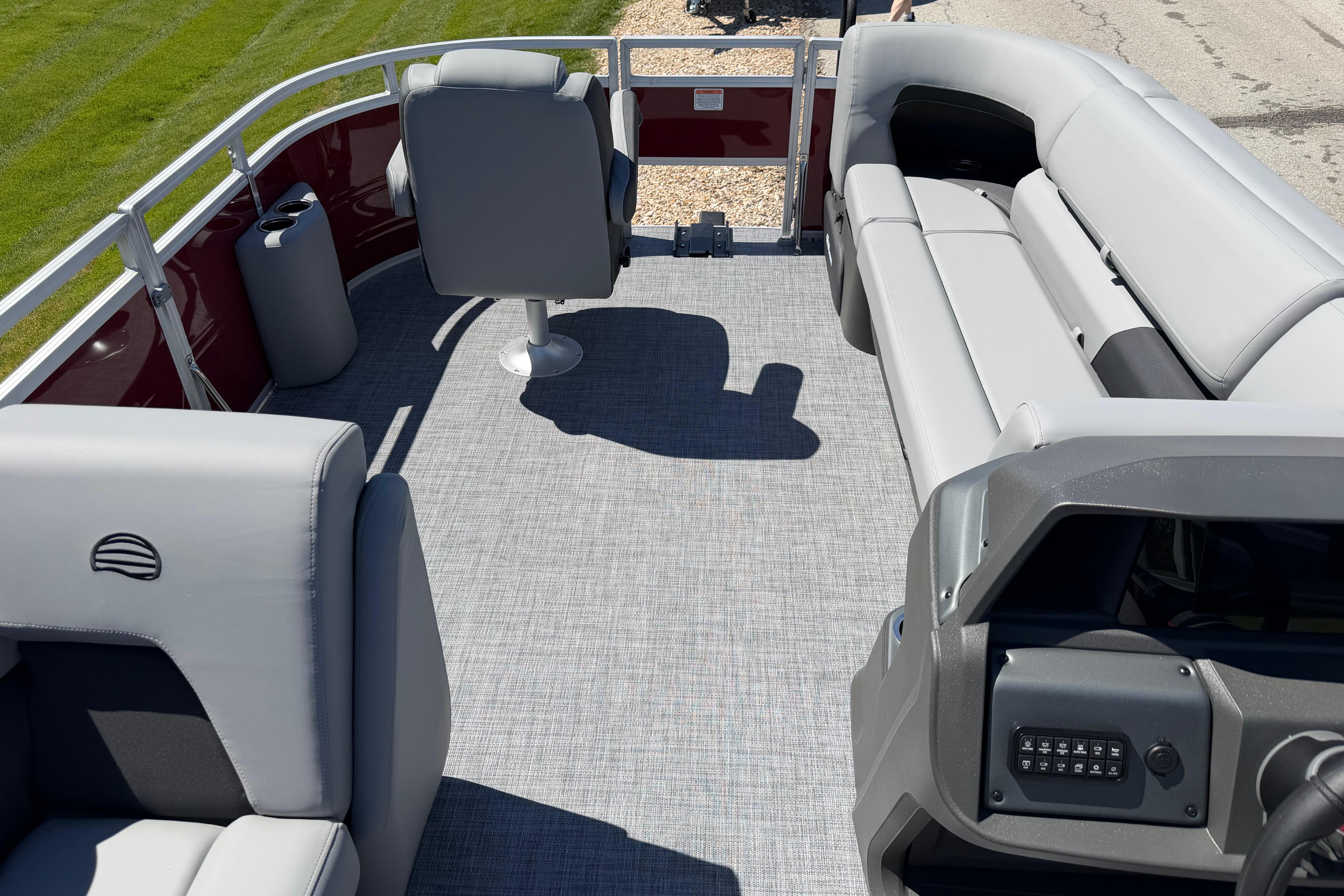 2026 Sun Tracker SportFish 20 DLX pontoon boat interior with gray seating and helm.