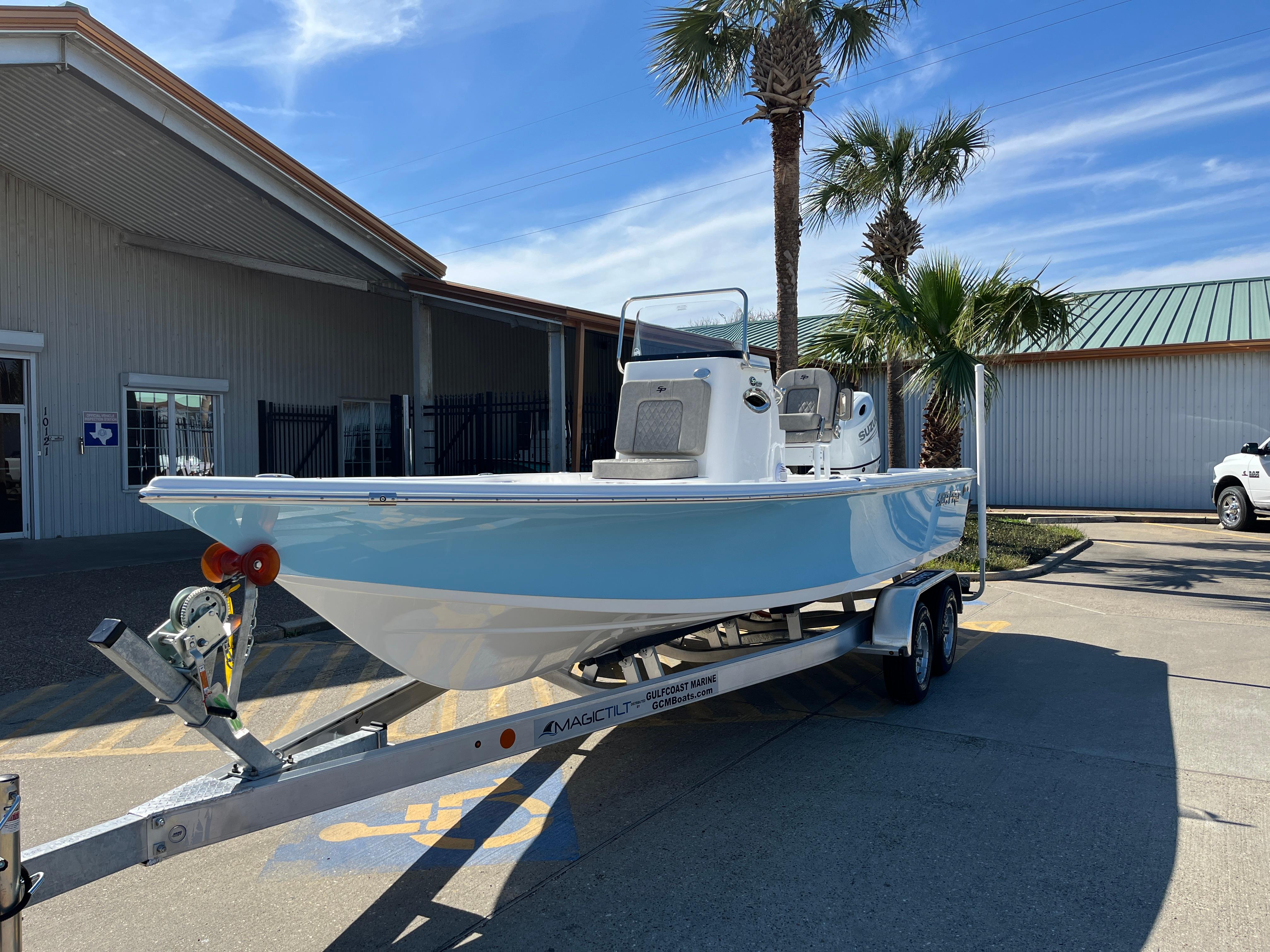 2024 Sea Pro 230 Bay boat on a trailer outside a building with palm trees.