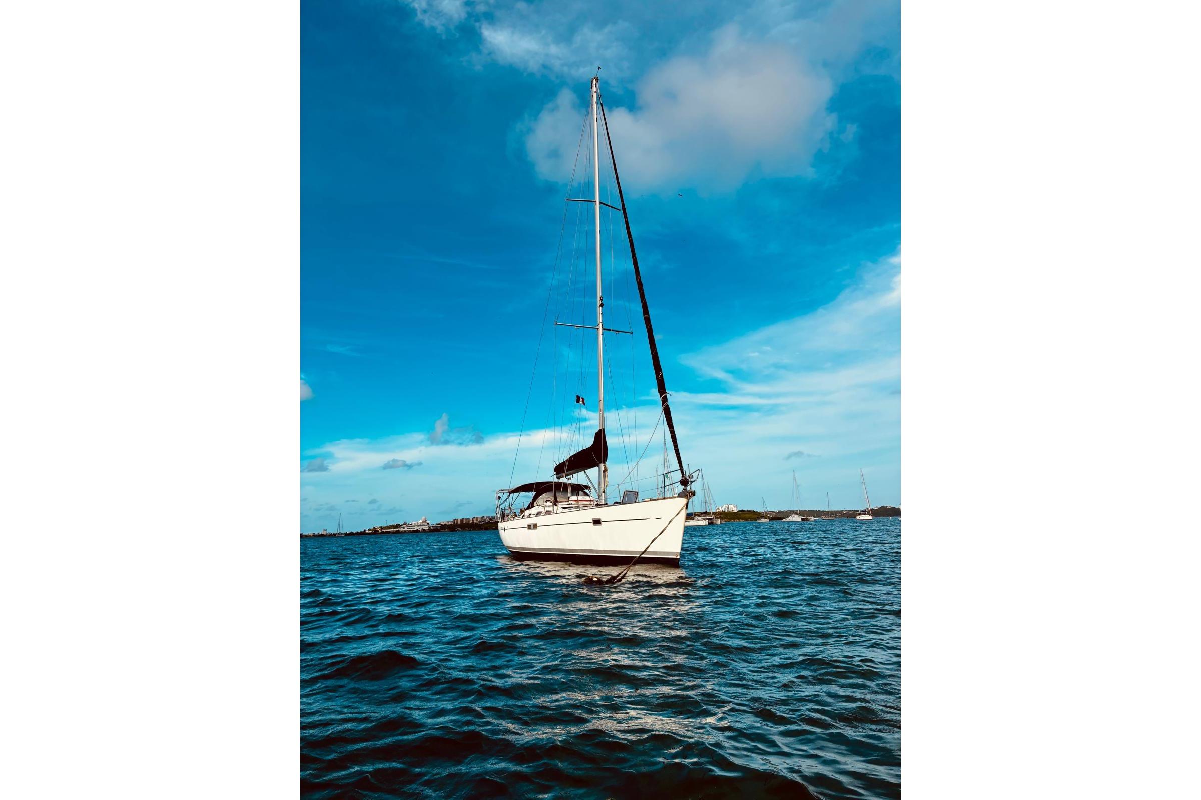 Sailing yacht Beneteau Oceanis 473, 2005 model, on calm blue waters under a clear sky.