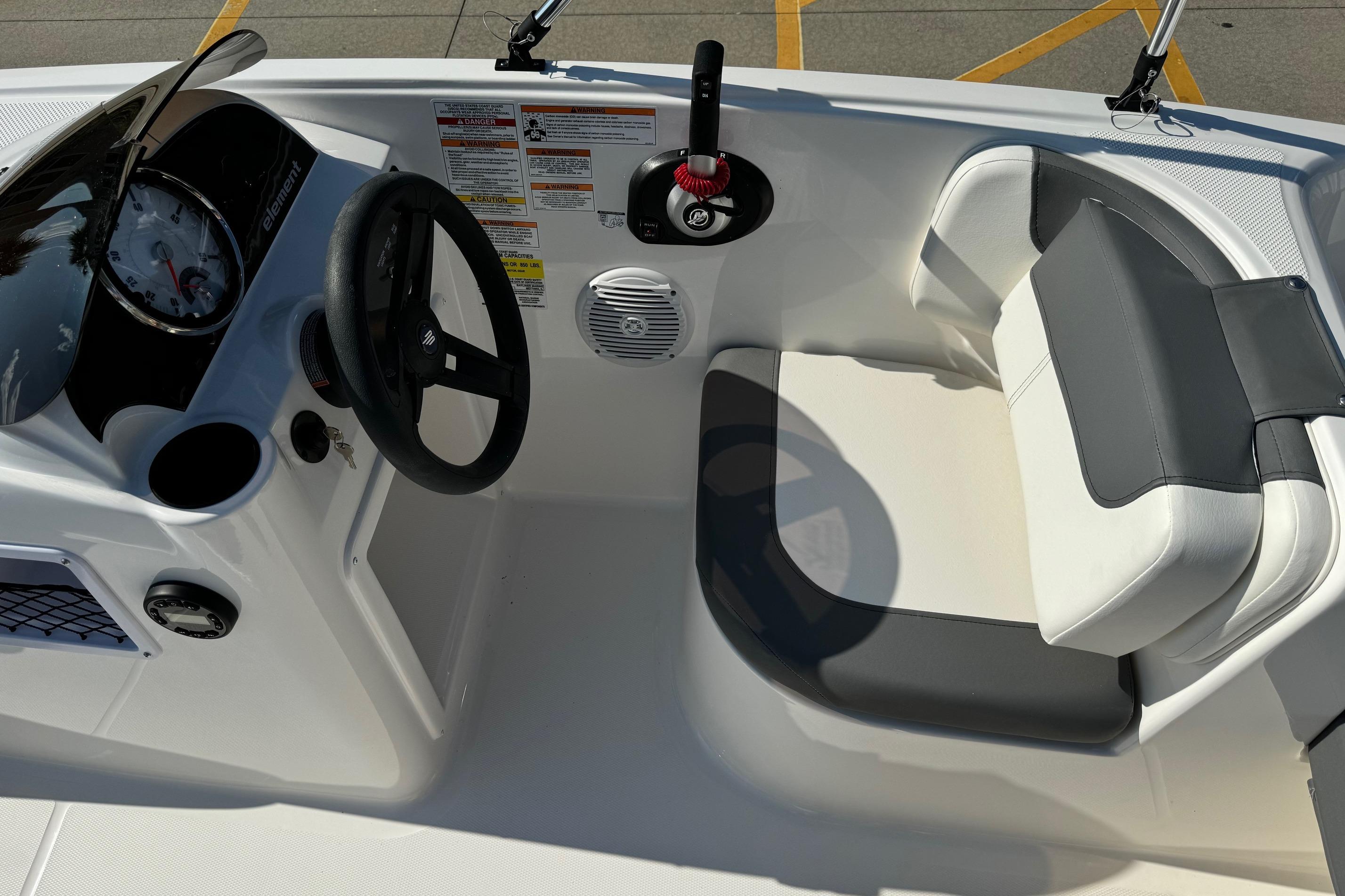 2025 Bayliner Element E16 boat interior with steering wheel and seating area.