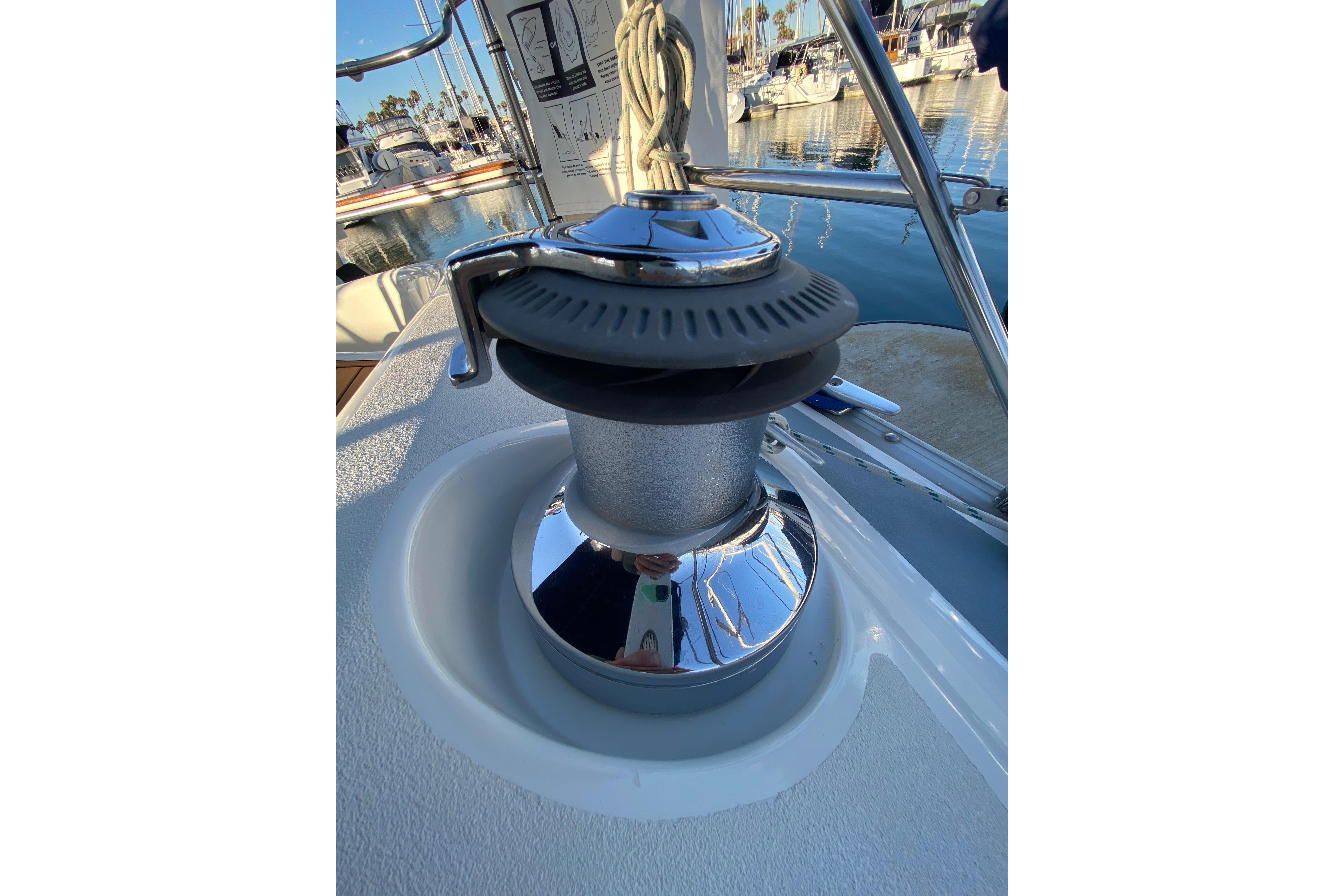 Winch on 1997 Hunter Legend 40.5 sailboat deck, marina background.