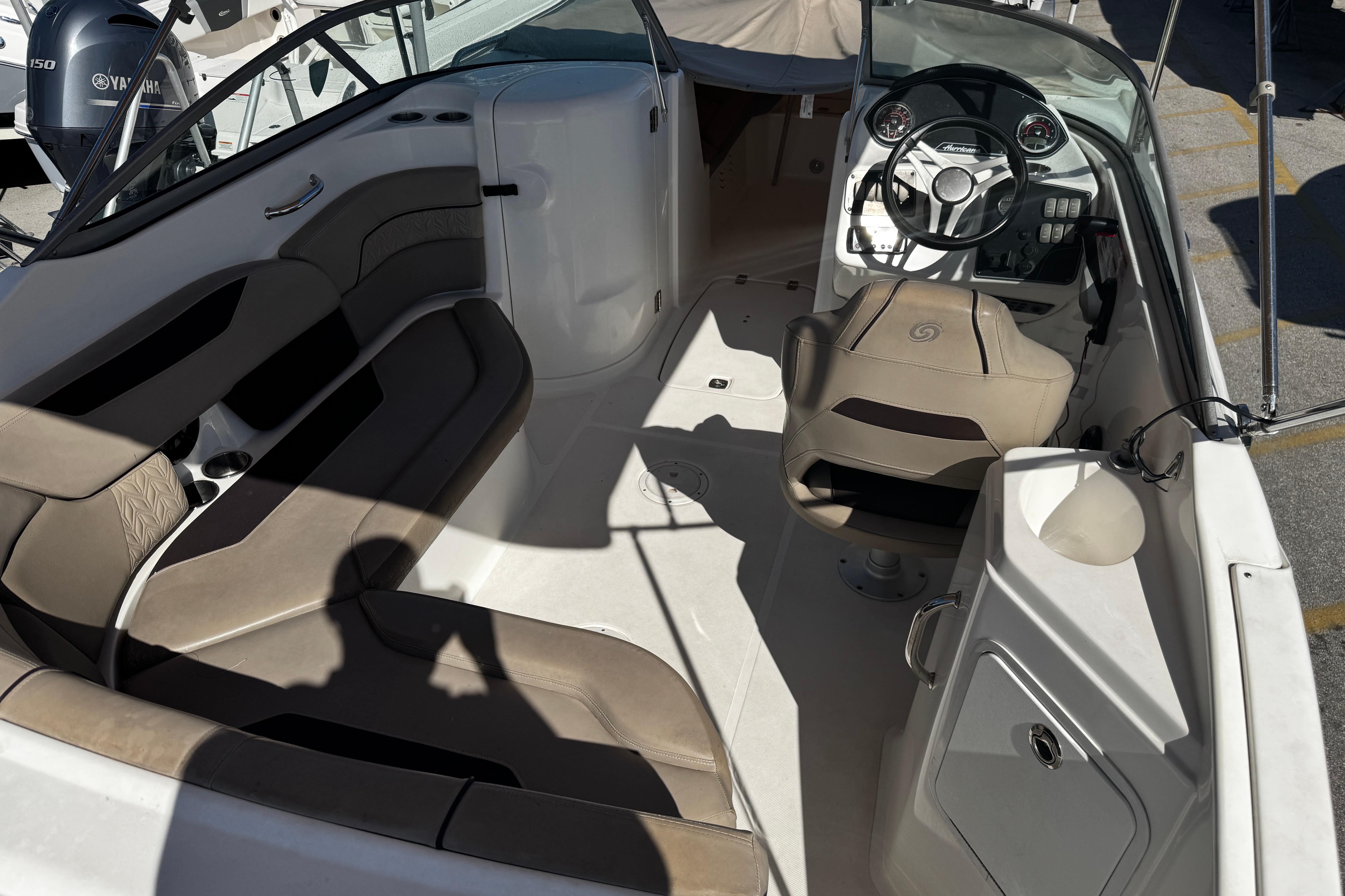 2021 Hurricane SunDeck 2200 DC OB boat interior with seating and steering console.