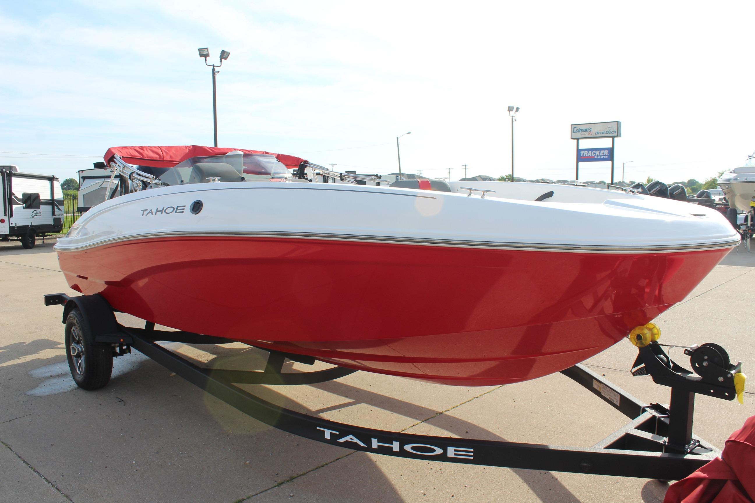 2026 Tahoe T18 boat with red and white design on a trailer in a parking lot.