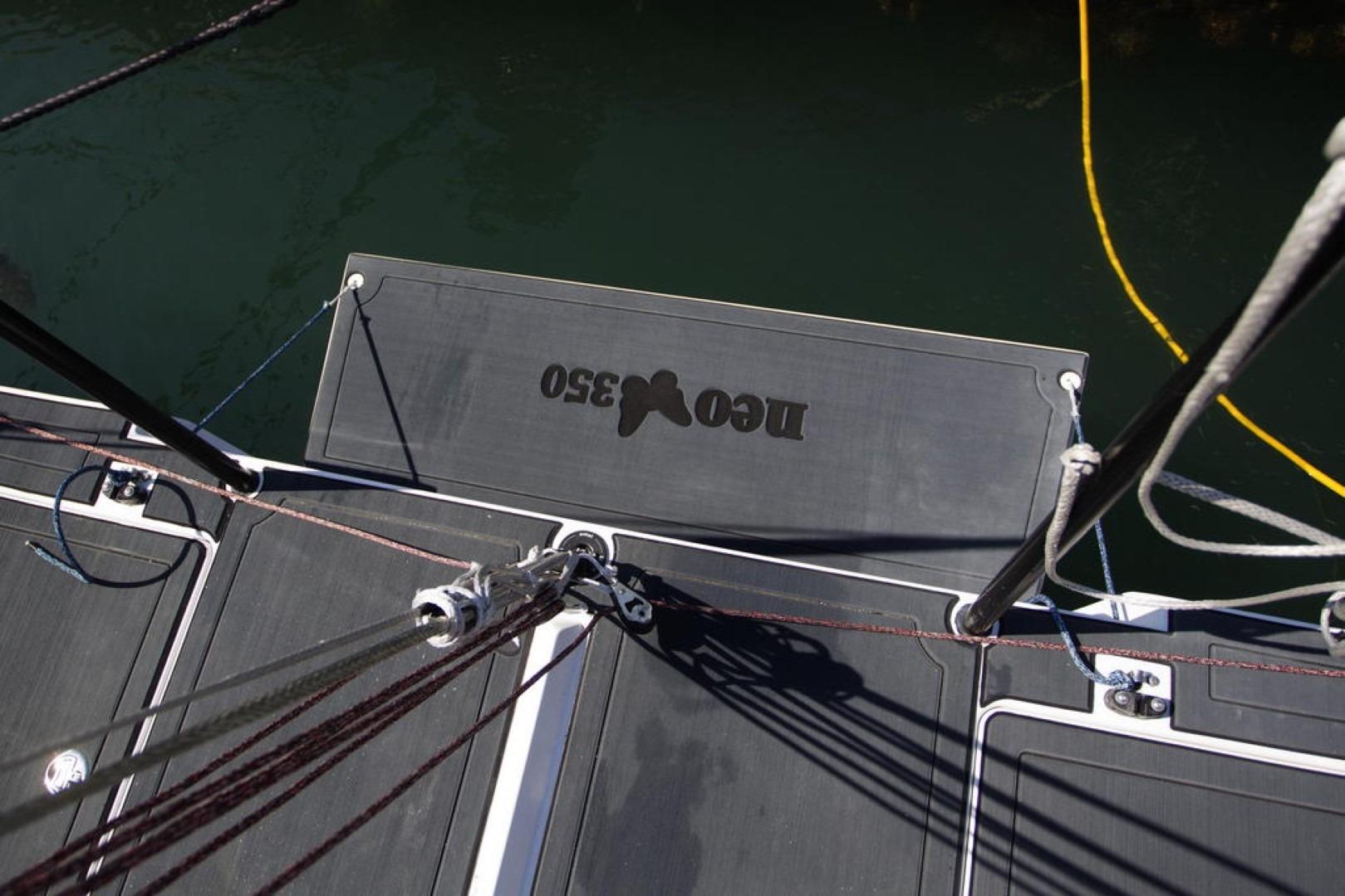 Deck view of a 2018 Neo 350 sailboat with visible rigging and branding.