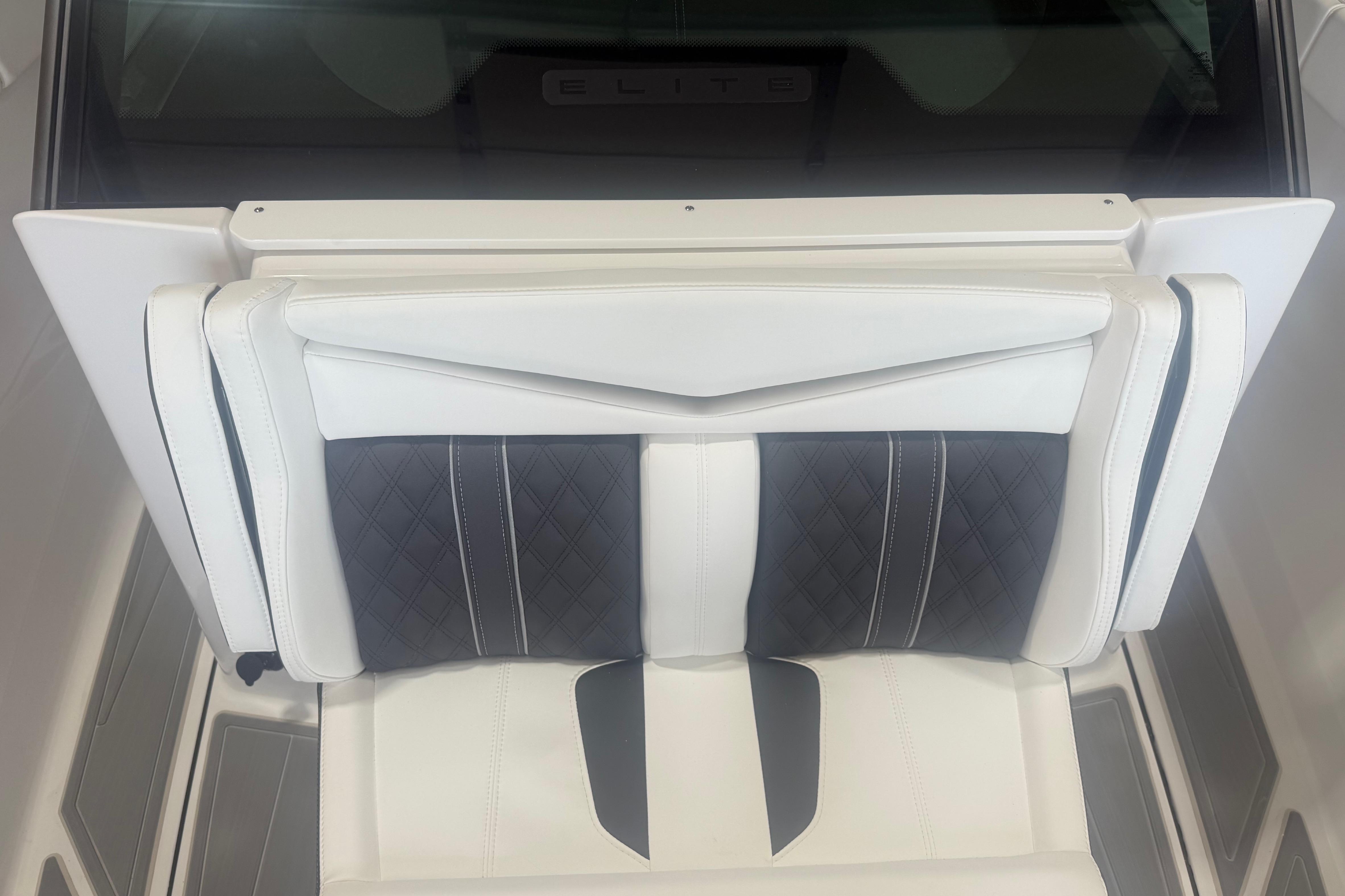 Luxurious seating in 2027 Monterey Elite 27 SD boat, featuring elegant white and black upholstery.