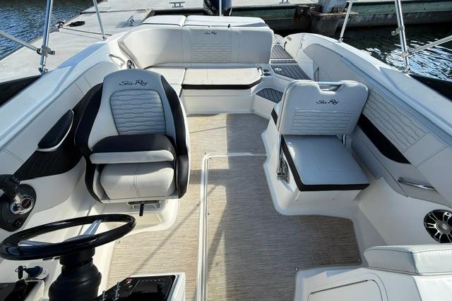 2022 Sea Ray SPX 210 Outboard boat interior with stylish seating and steering wheel.