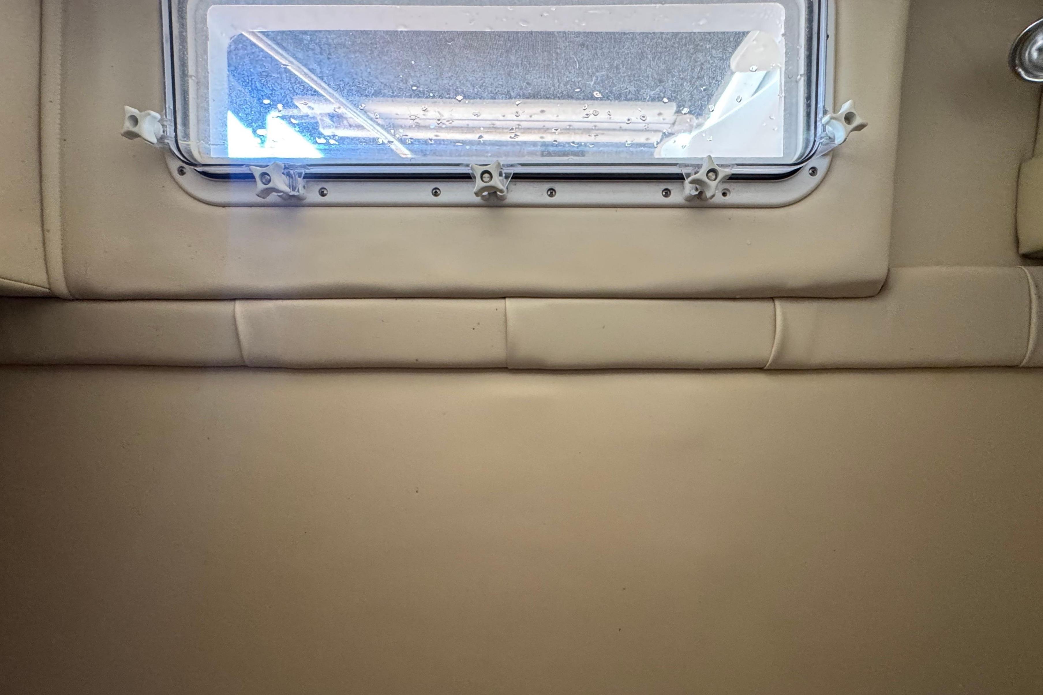 Interior cabin view of a 2008 Larson Cabrio 260 boat with a window.