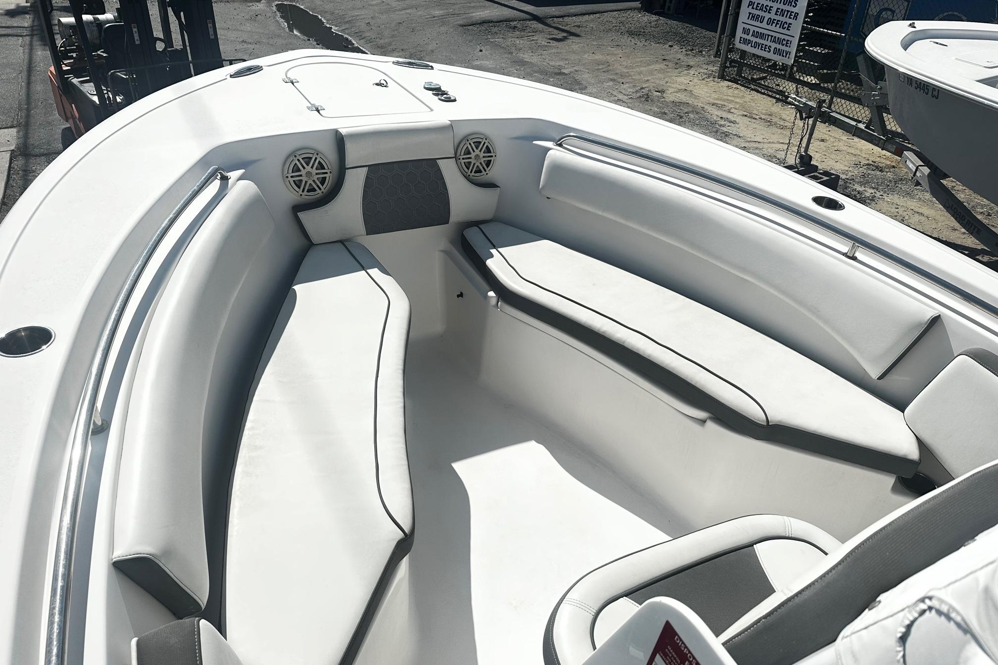 2020 Tidewater 230 CC Adventure boat interior with white seating and speakers.