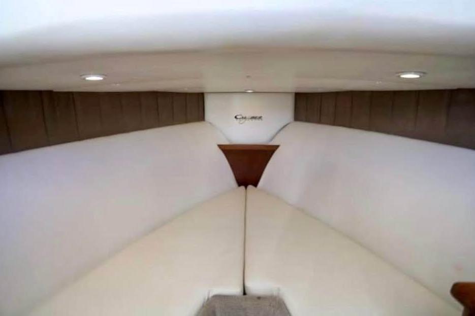 Interior cabin of 2006 Calyber 29 Express boat with cushioned seating.