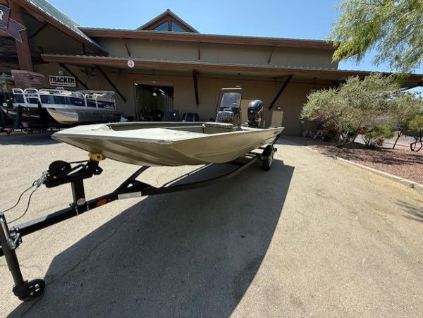 2025 Tracker Grizzly 1860 CC boat on trailer outside dealership.