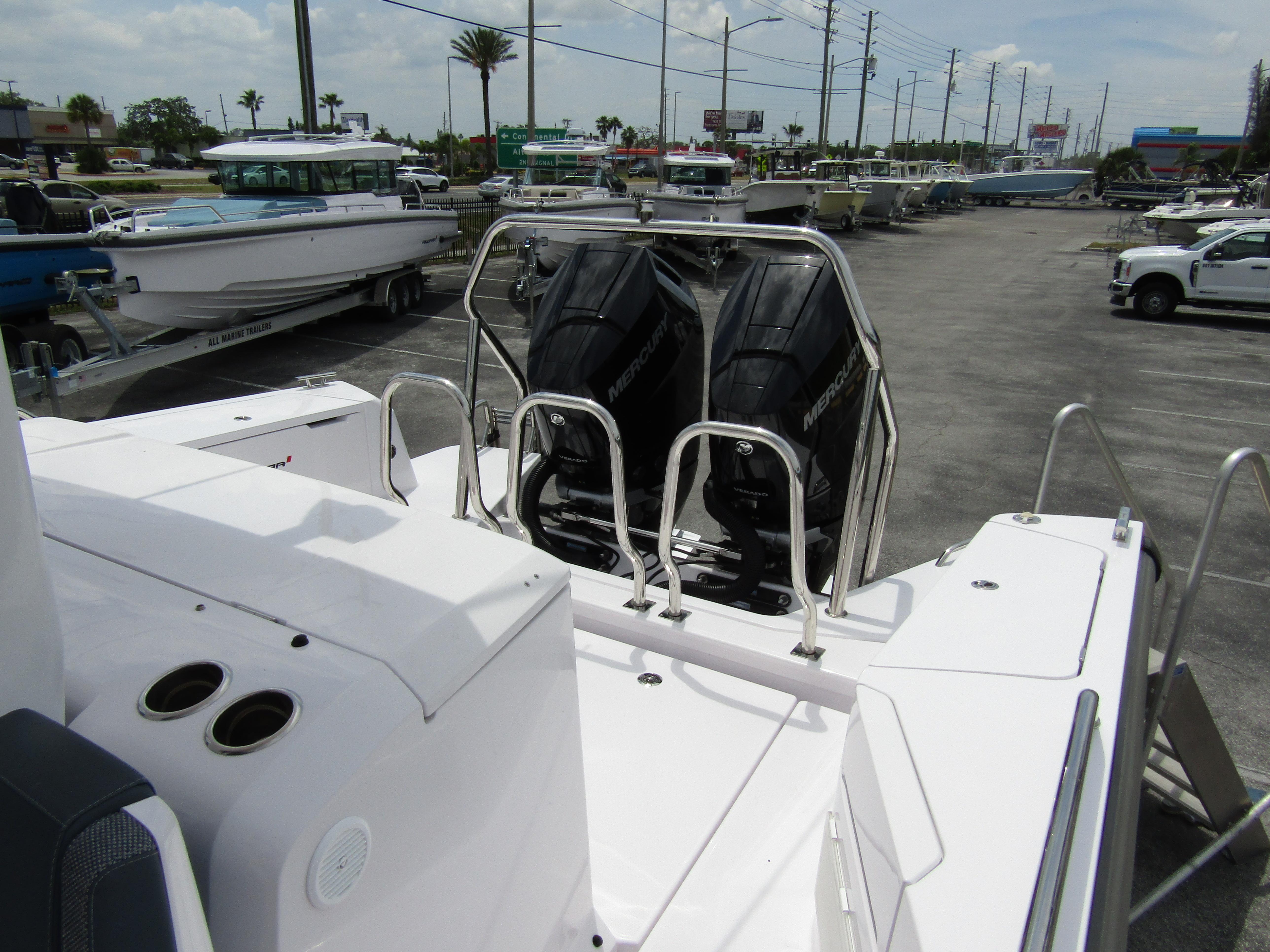 2024 Axopar 37 Sun Top with dual outboard engines in a marina setting.