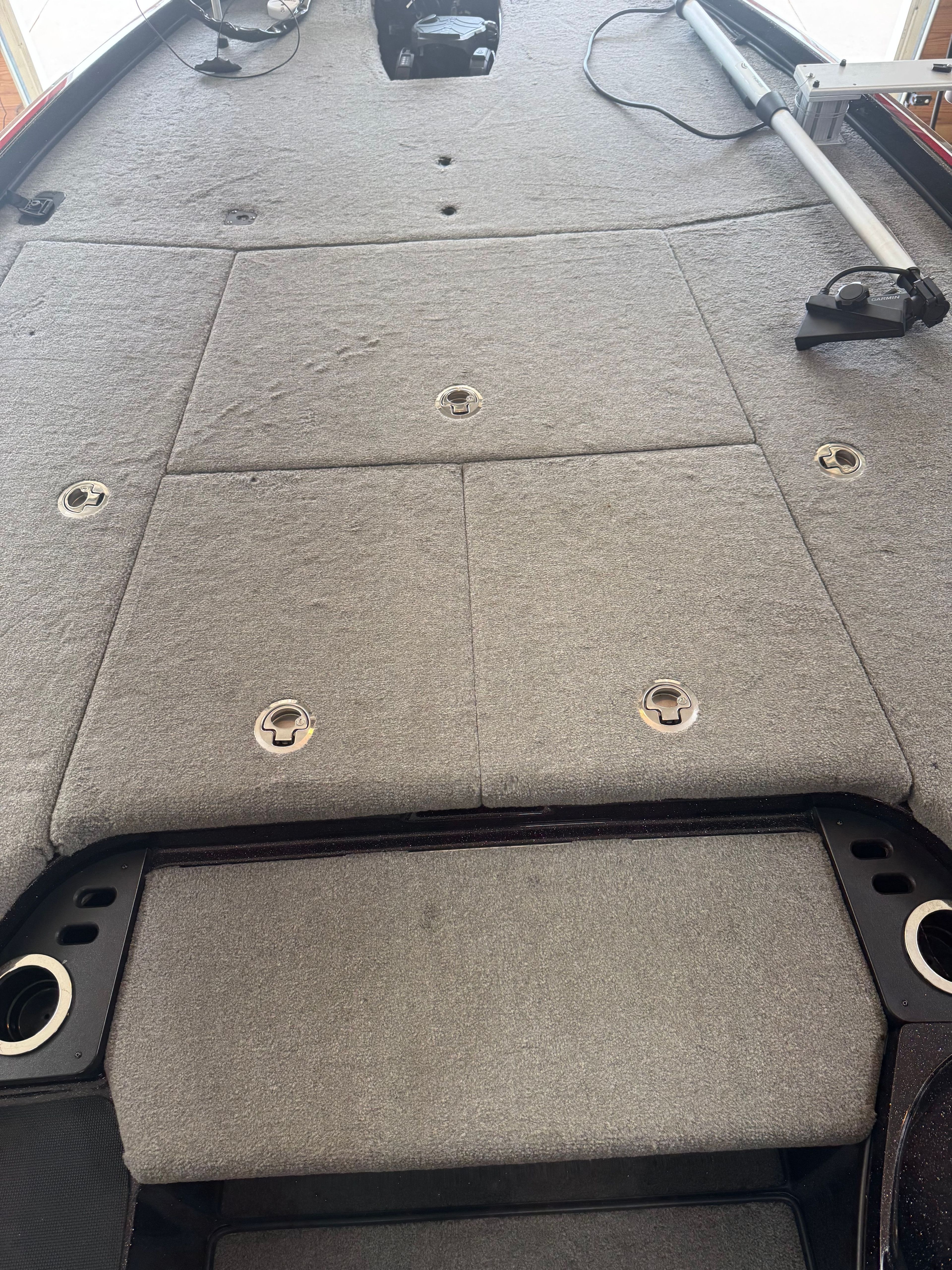 The image shows the deck of a Nitro Z21 boat with gray carpeting.