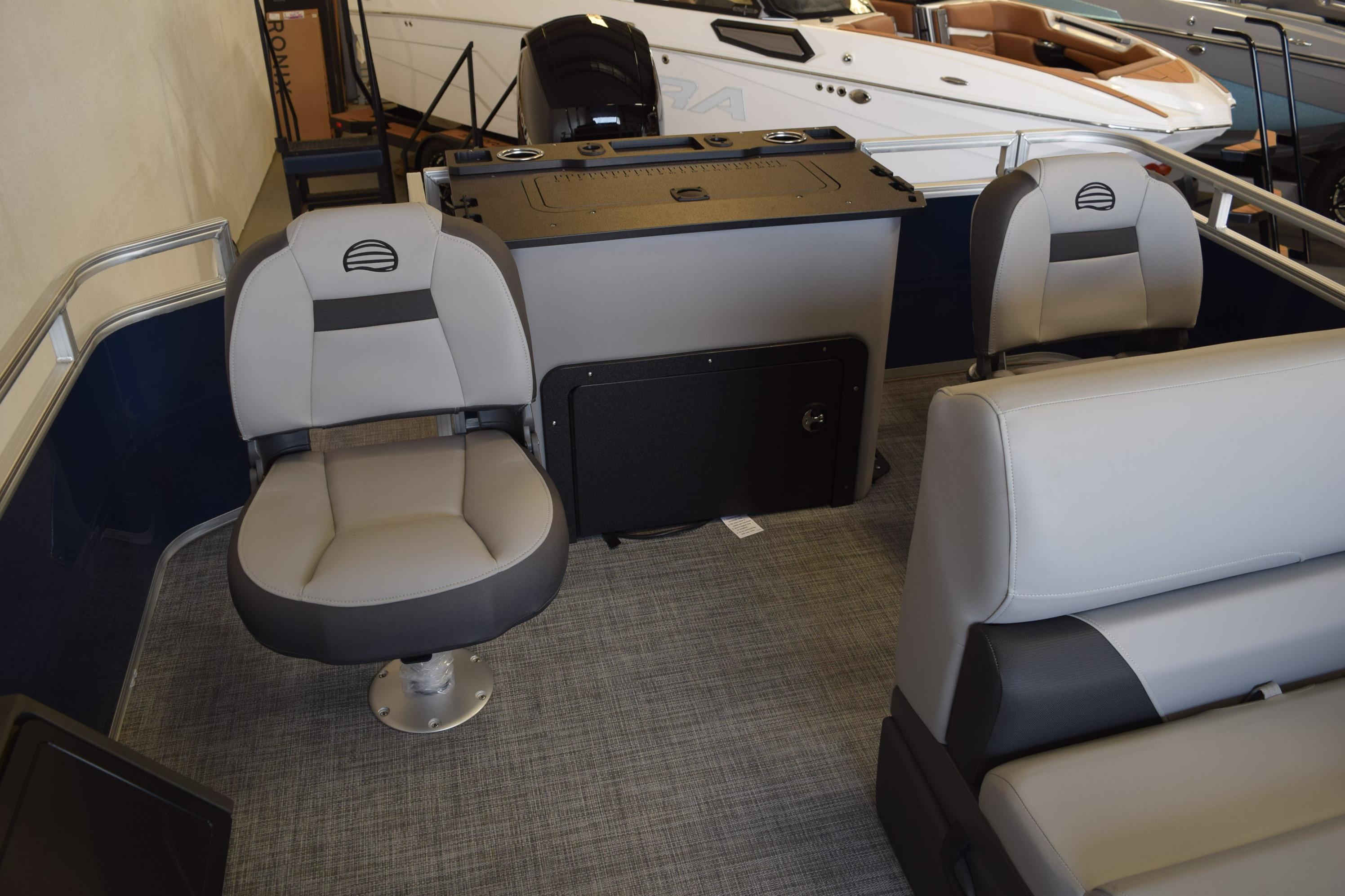 Interior of 2026 Sun Tracker SportFish 22 DLX pontoon boat with seating and helm.