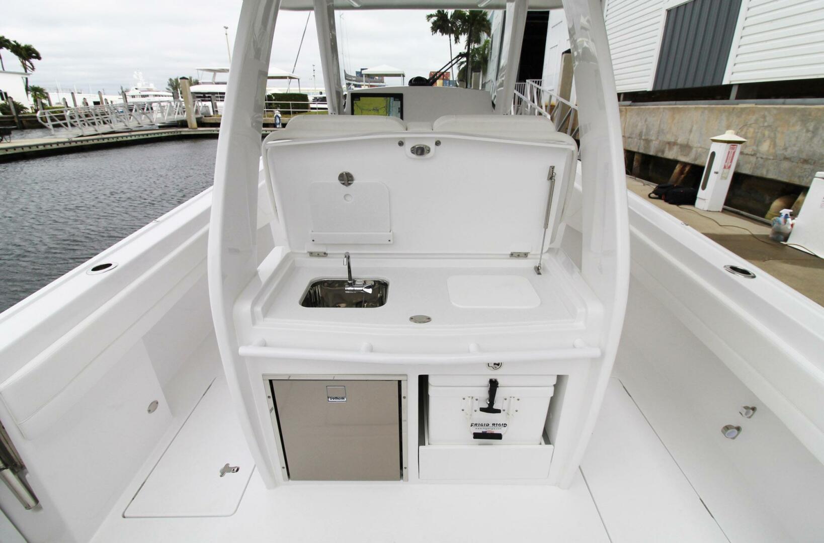 2024 Intrepid 375 Nomad SE boat interior with sink and storage compartments.
