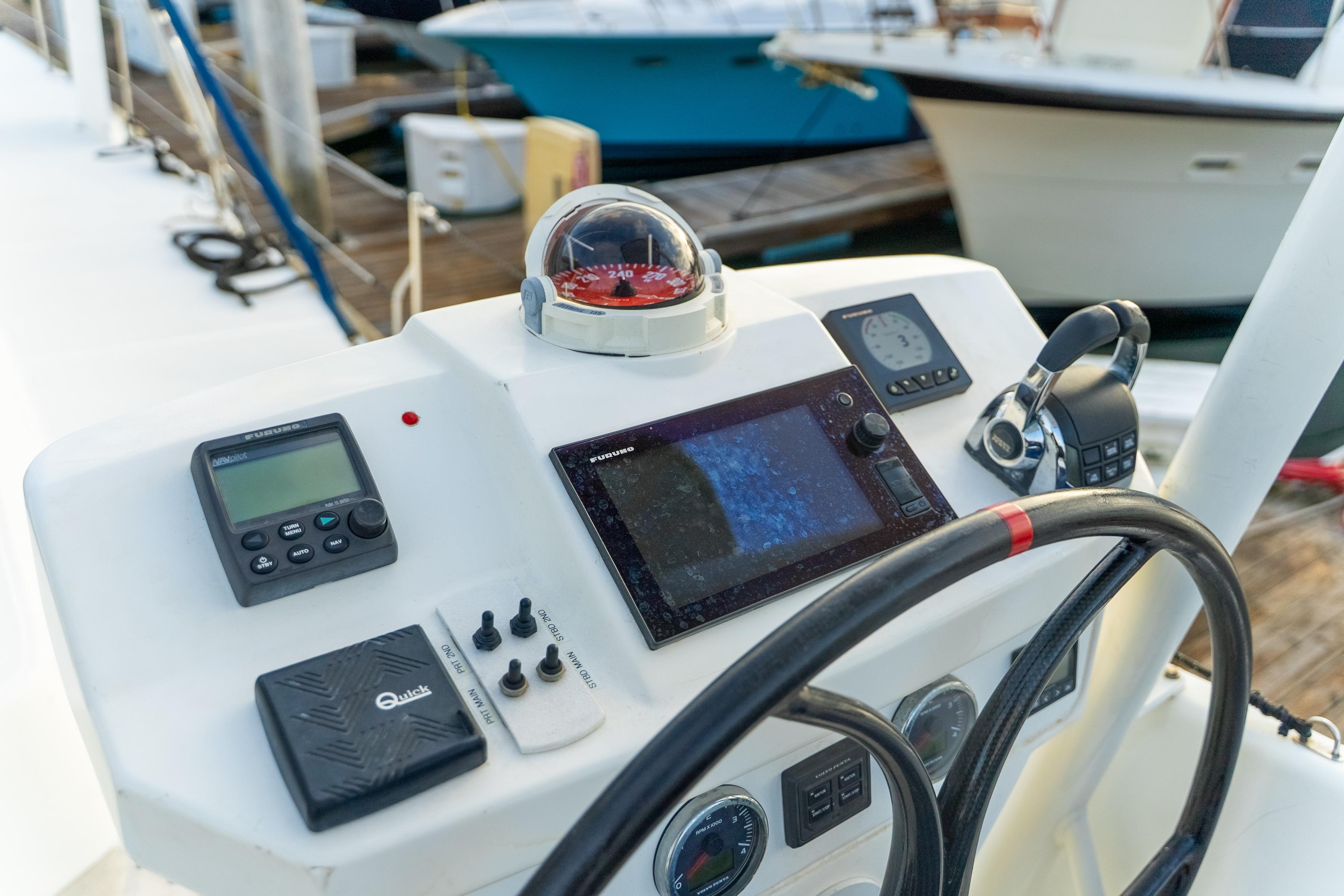 Cockpit of 2009 Catana 65 yacht with navigation instruments and steering wheel.