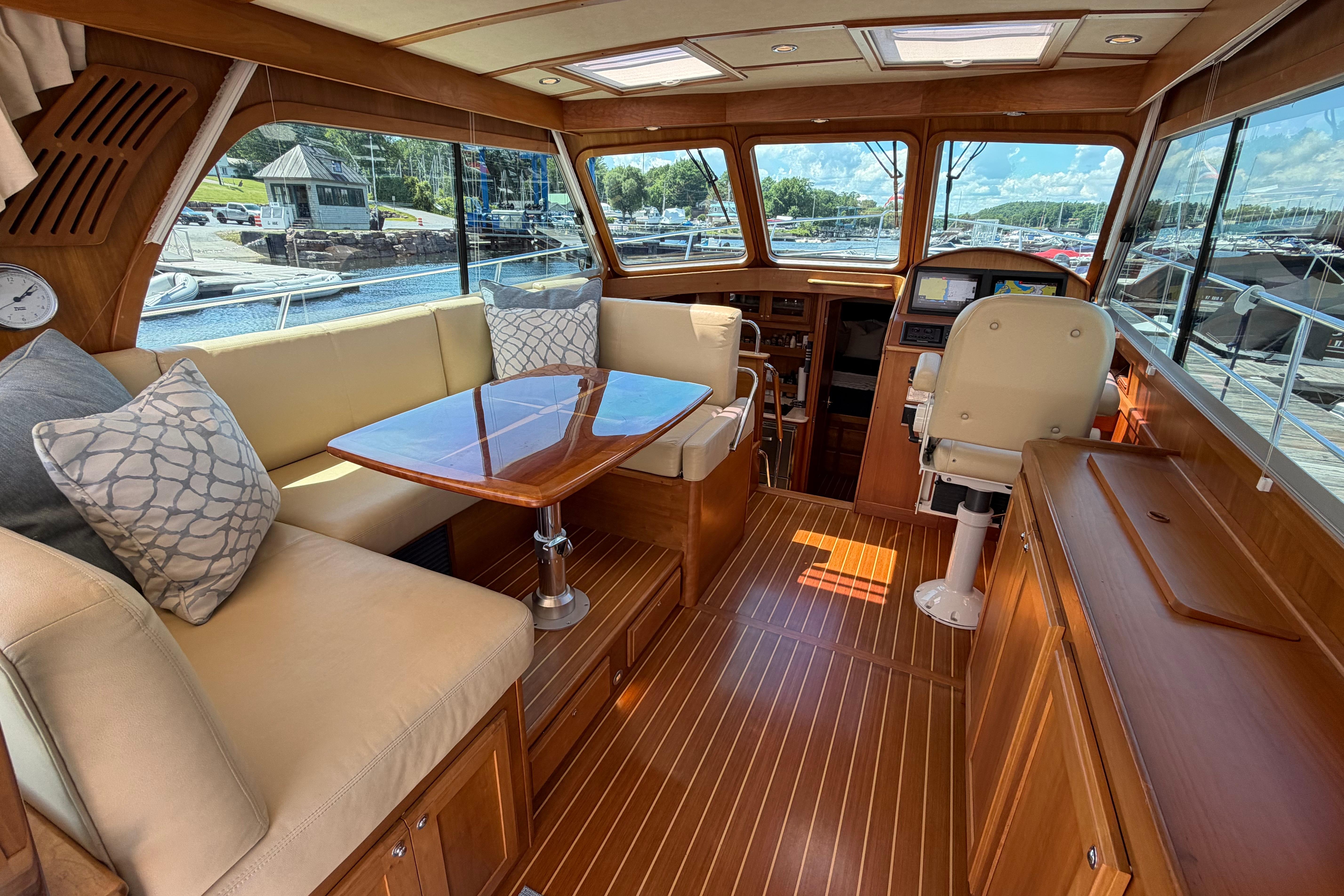 Luxurious interior of 2015 Sabre 38 Salon Express yacht with elegant wood finish and plush seating.