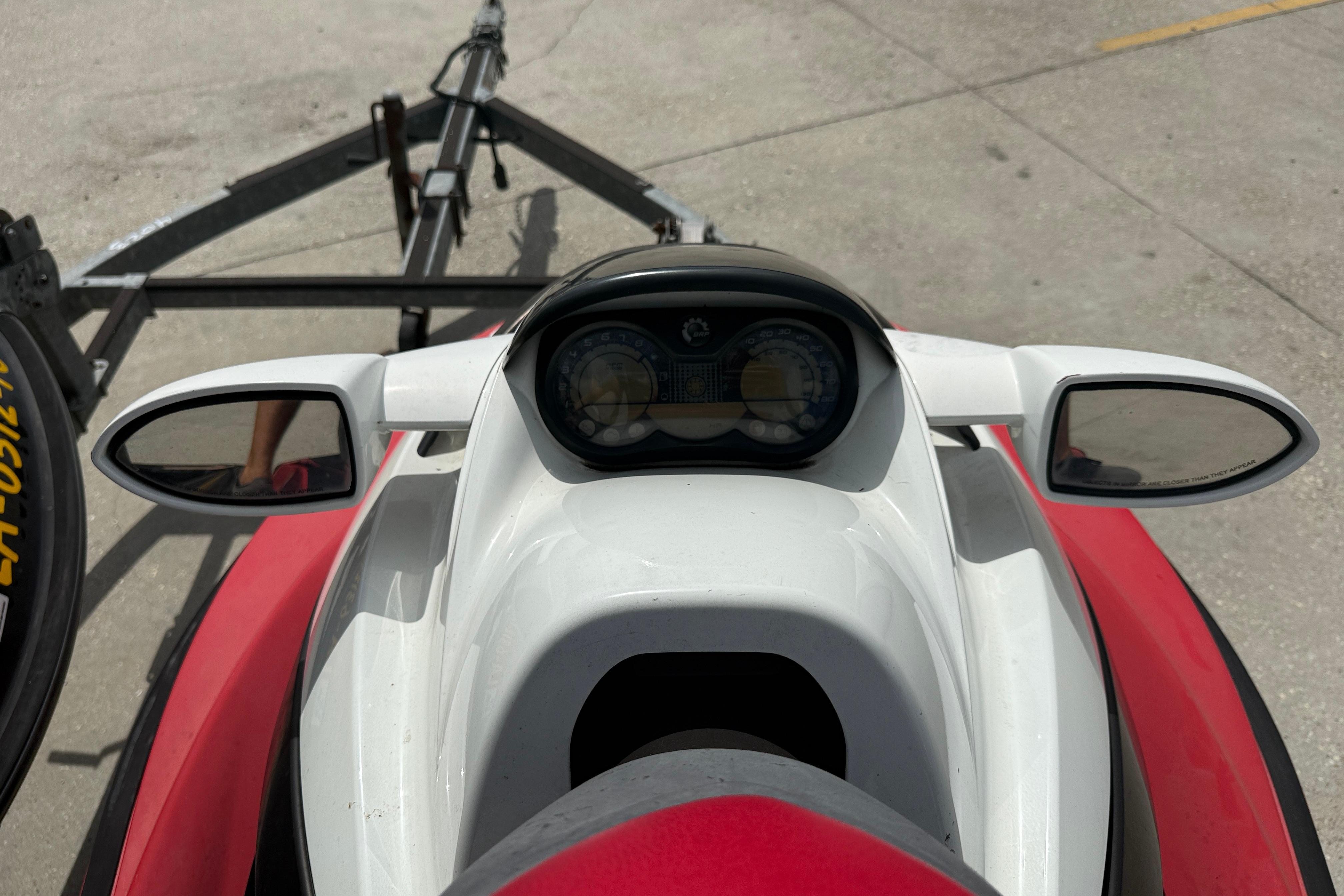 2007 Sea-Doo RXT 215 jet ski dashboard and mirrors, parked on a trailer.