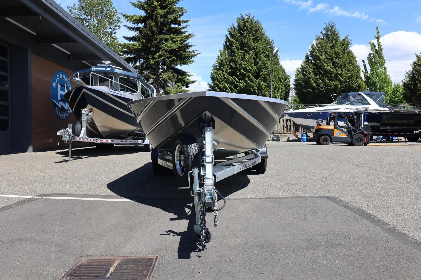 2026 Thunder Jet 209 Rush OT boat on trailer, parked outdoors near marine shop.