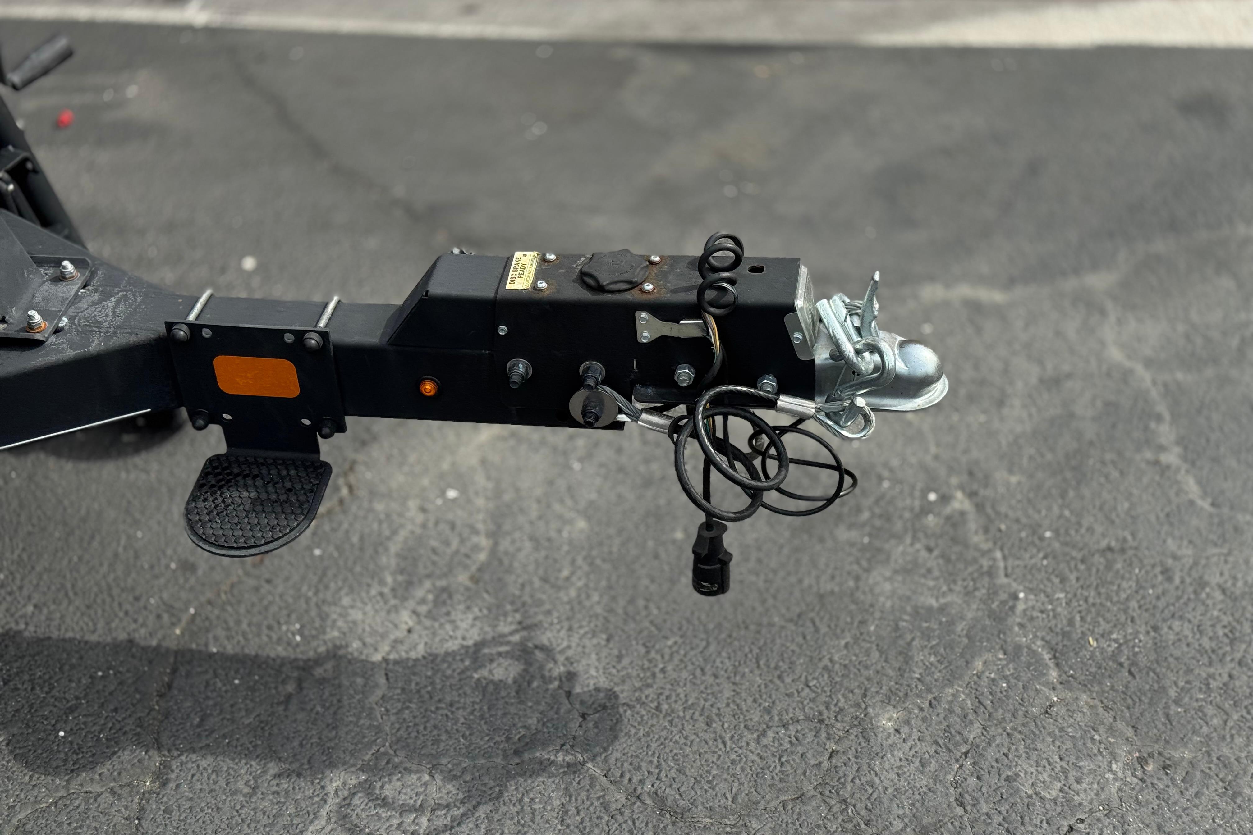 Trailer hitch of a 2022 Regency 250 DL3 on asphalt surface.