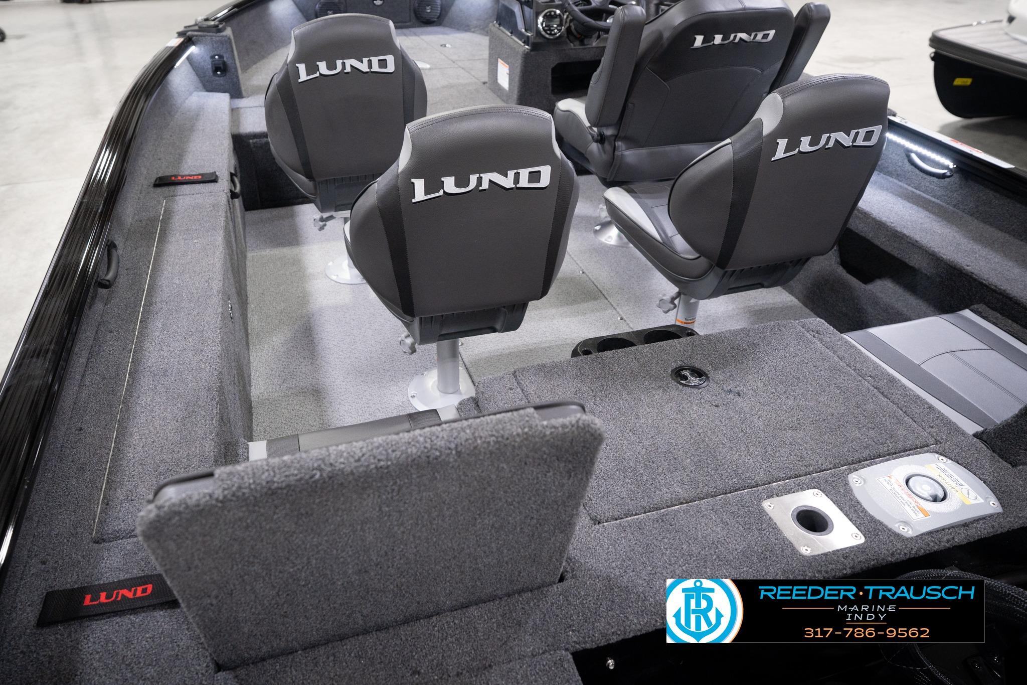 2026 Lund 1775 Impact XS SS boat interior with four seats and carpeted flooring.