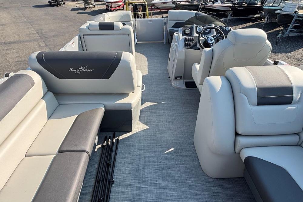 2024 SunChaser Geneva Cruise 22 LR PSB pontoon boat interior with plush seating and modern dashboard.