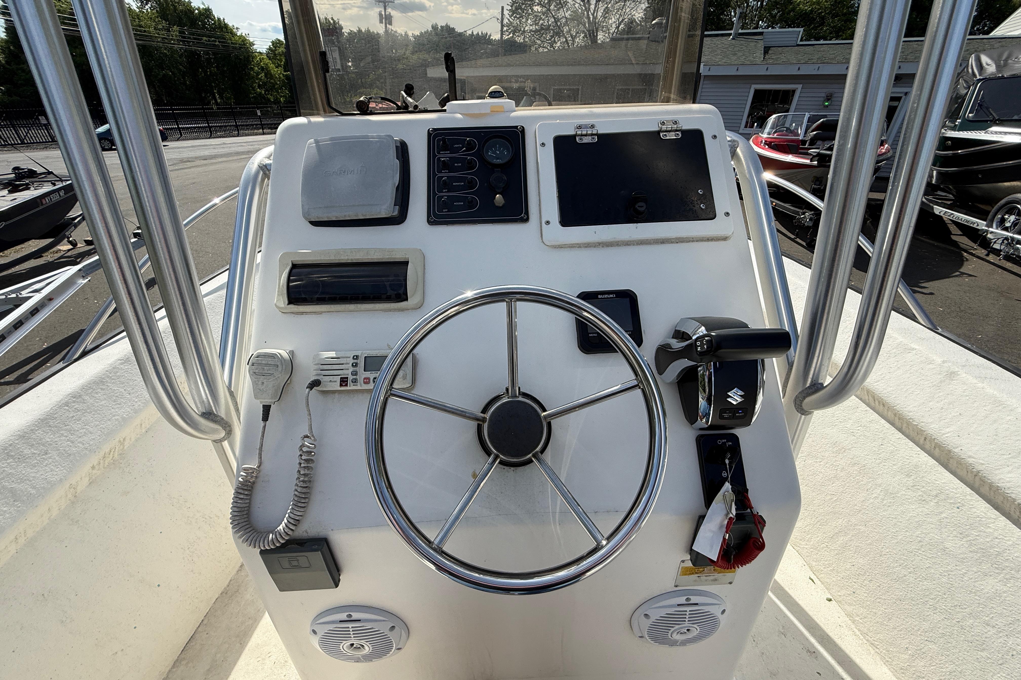 Center console of a 2008 Key Largo 206 boat with steering wheel and controls.