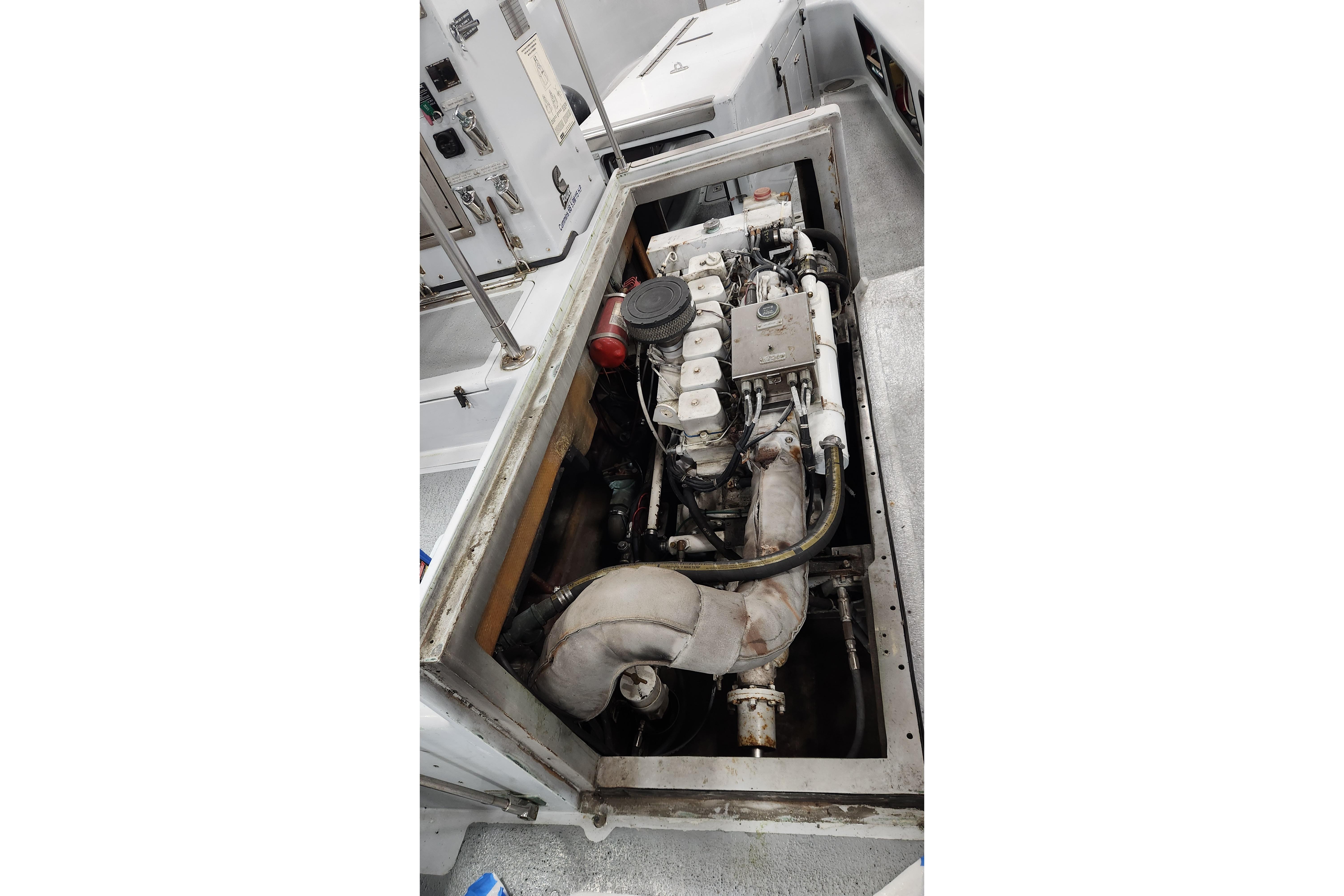 Engine compartment of a 1994 Willard US Navy vessel, showcasing mechanical components and layout.