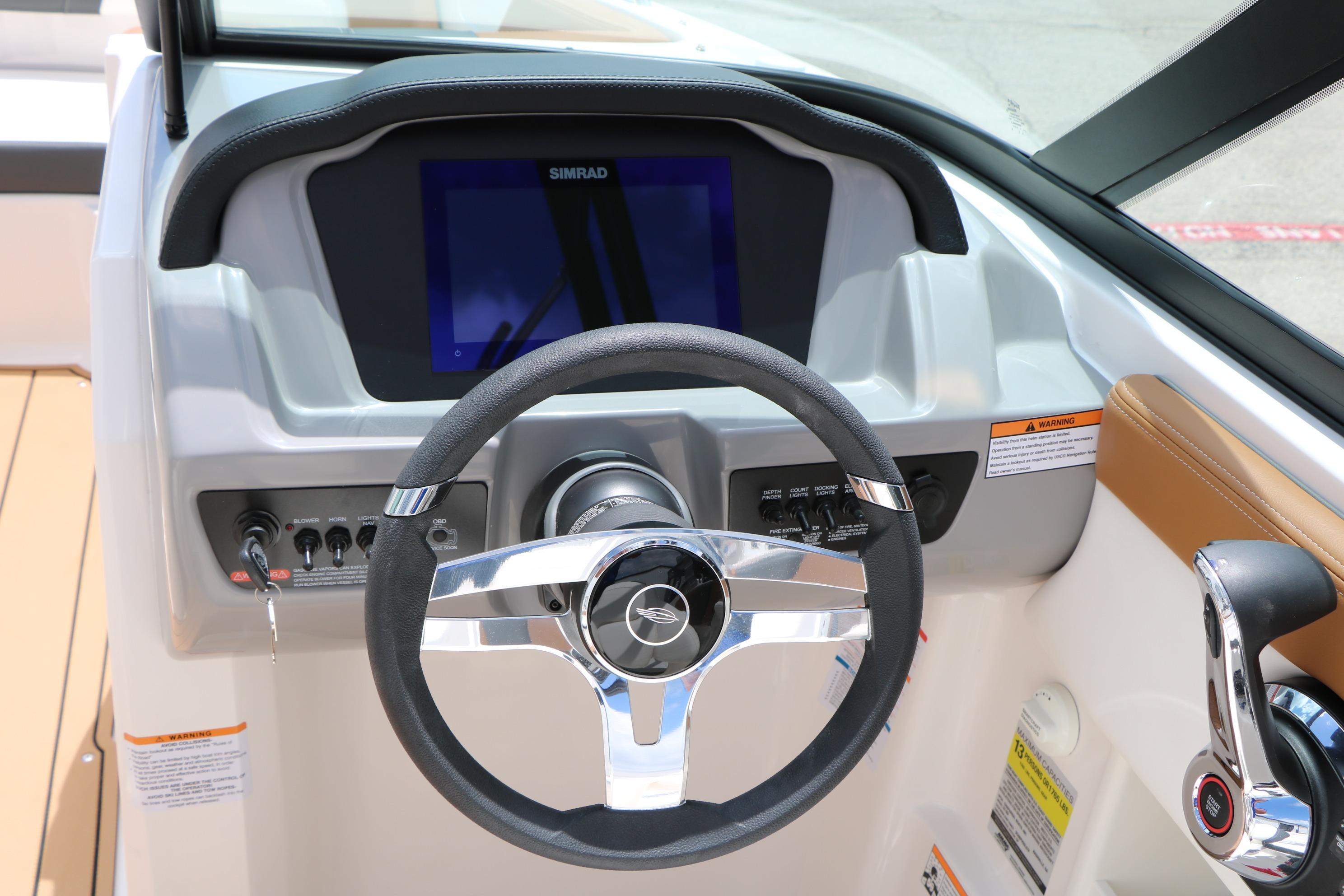 Steering console of 2025 Chaparral 23 SSi boat with Simrad display and controls.