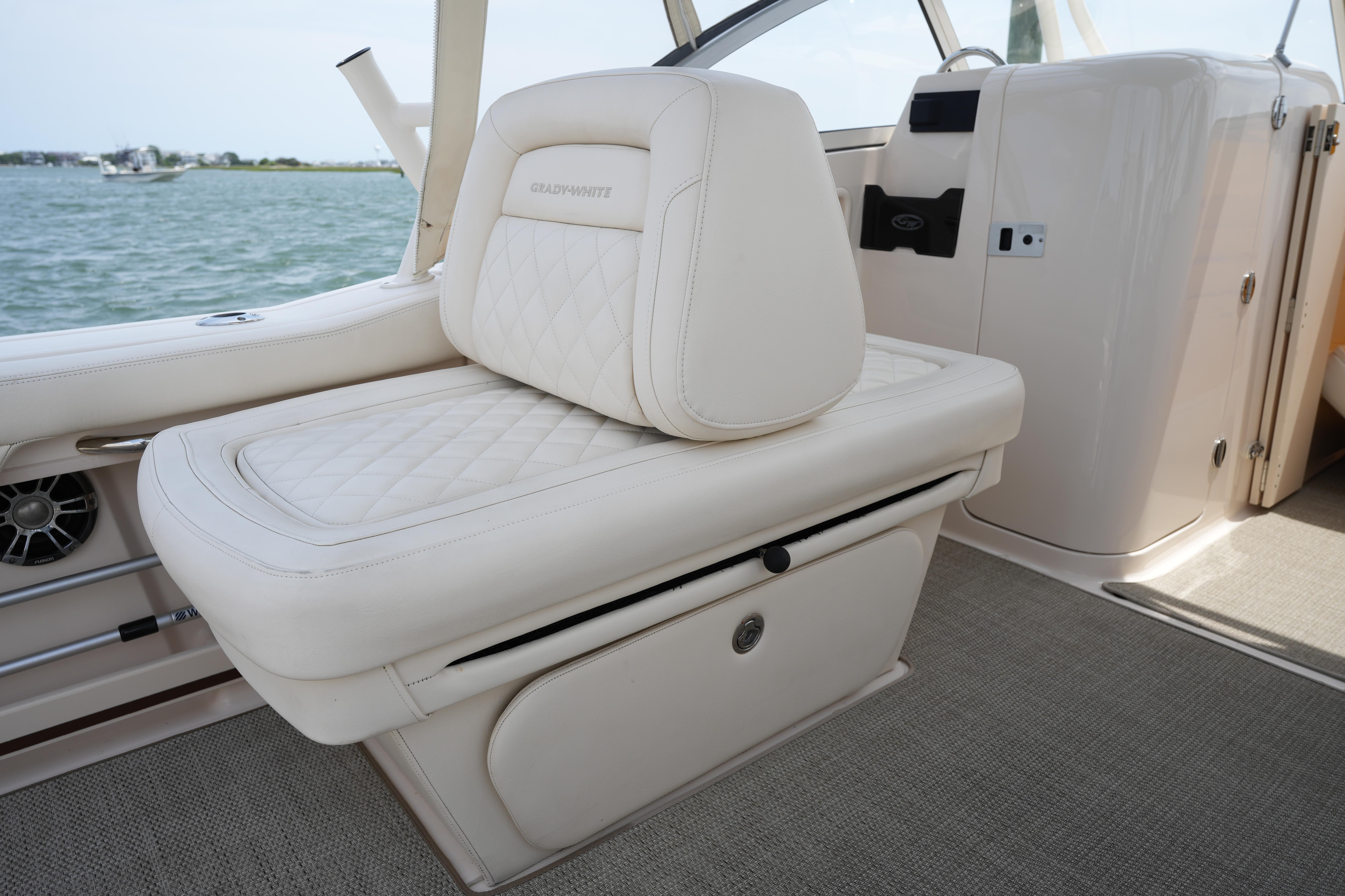 Luxurious seating on 2021 Grady-White Freedom 235 boat, featuring elegant white upholstery.