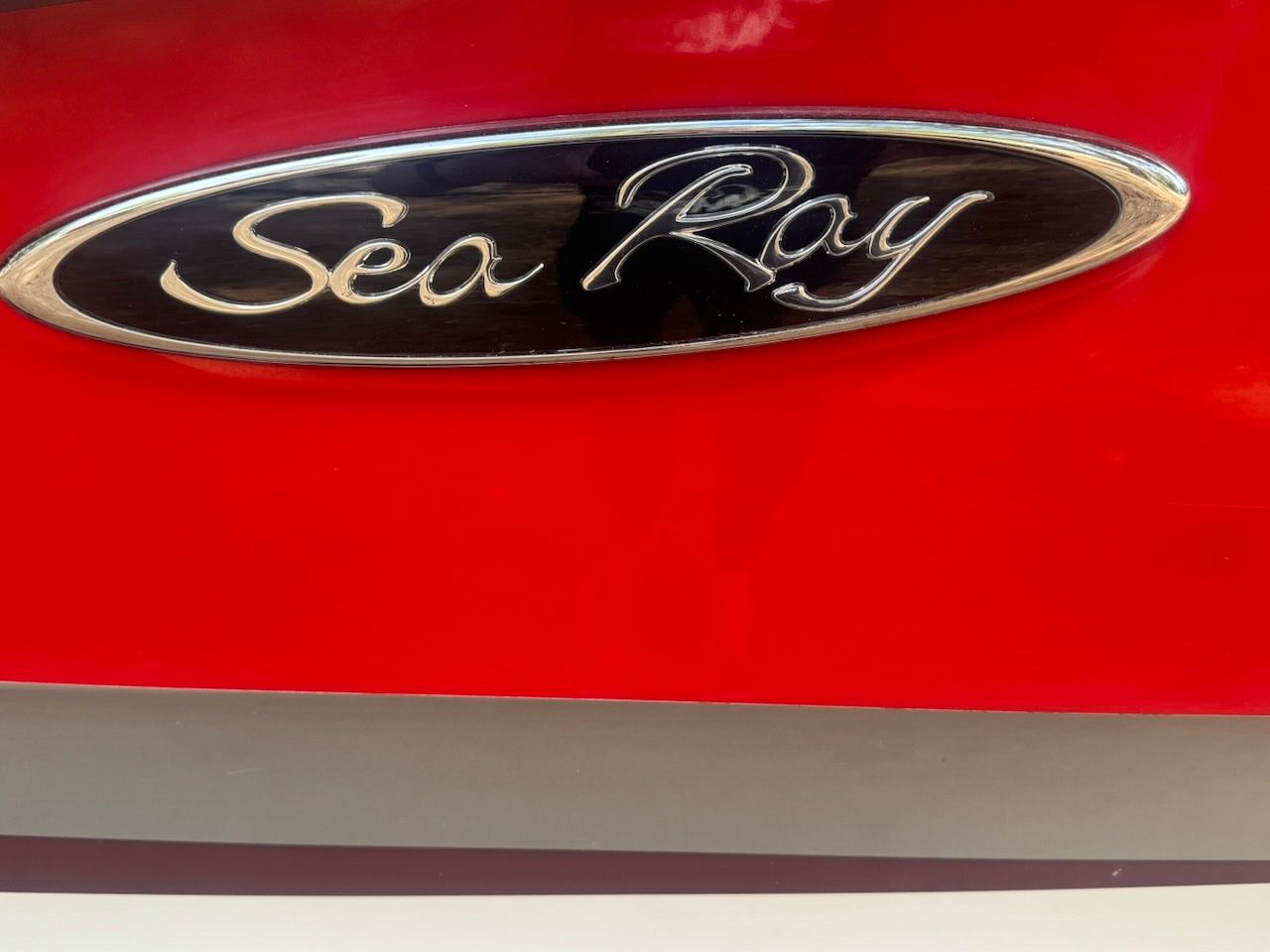 Close-up of the Sea Ray logo on a red boat.