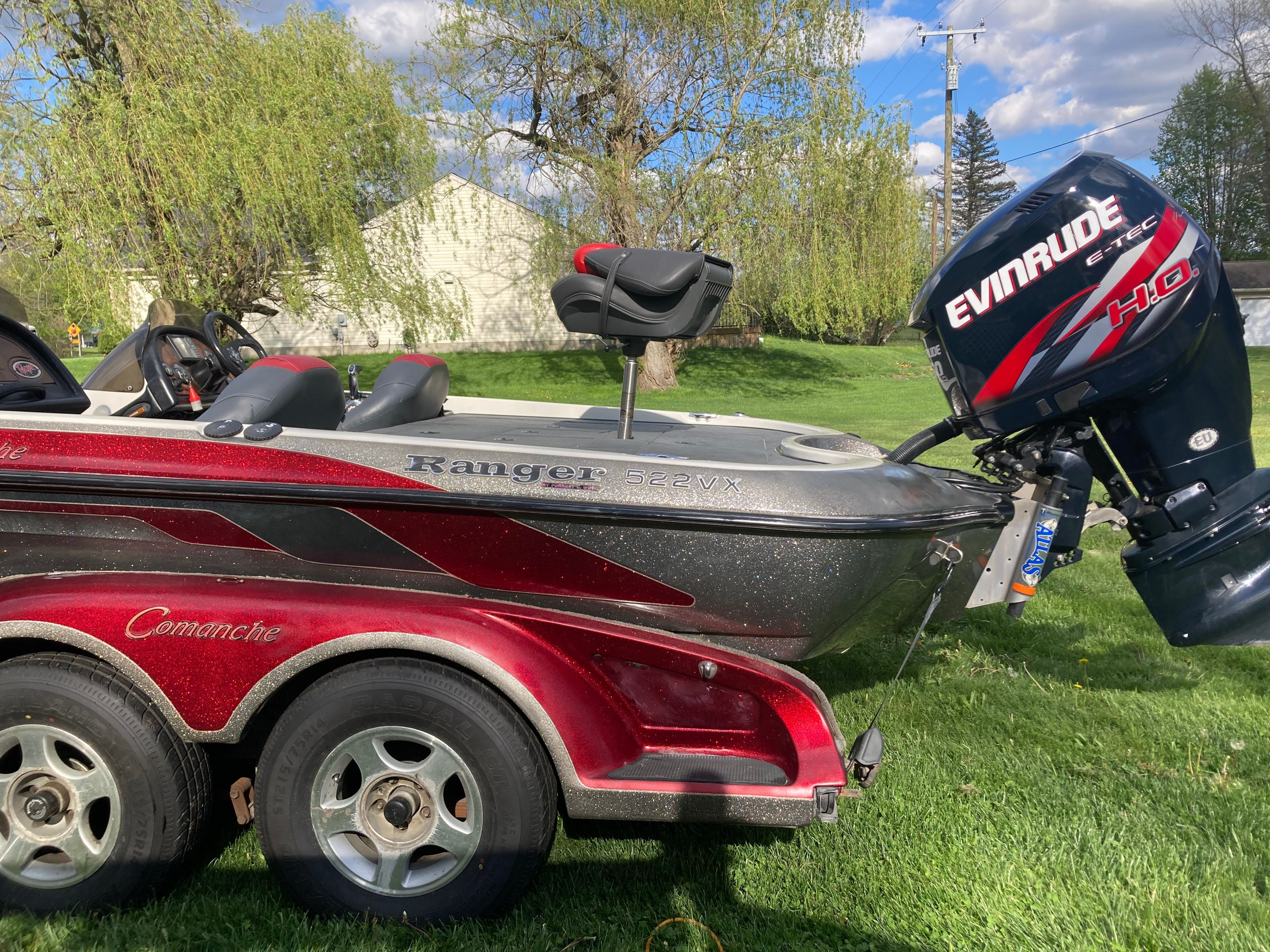 A 2002 Ranger 522DVX Comanche boat on a trailer, set in a grassy area.