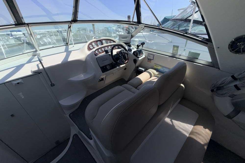 Interior view of a 2001 Monterey 282 Cruiser boat cockpit with steering wheel and dashboard.