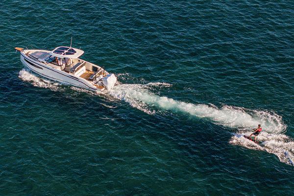 Manufacturer Provided Image: Aerial view of Navan S30 boat towing a wakeboarder on open water, 2026 model.