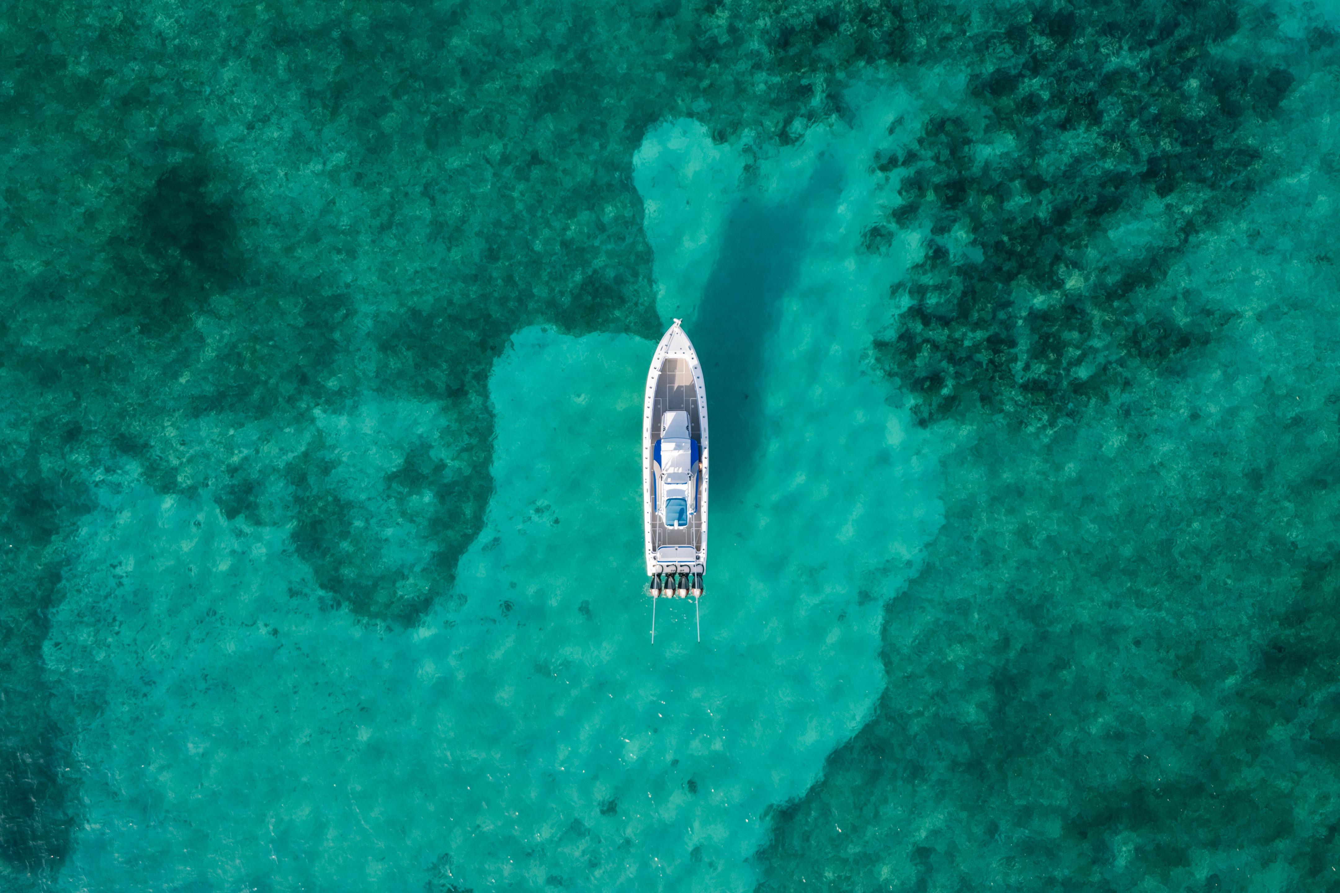 Aerial view of 2022 Nor-Tech 392 Super Fish boat on turquoise water.