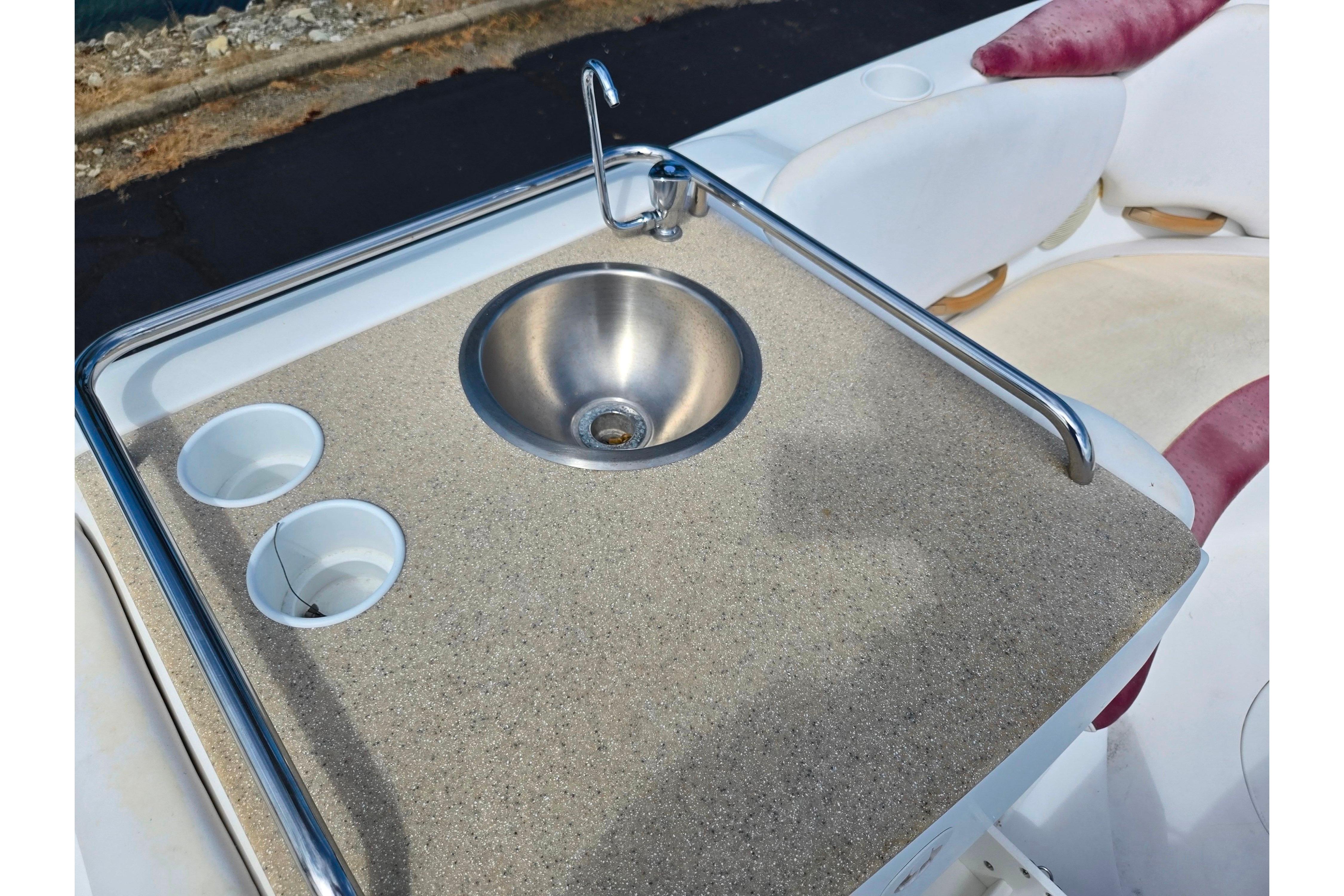 2004 Sea-Doo Islandia boat sink and countertop with cup holders, featuring stainless steel finish.