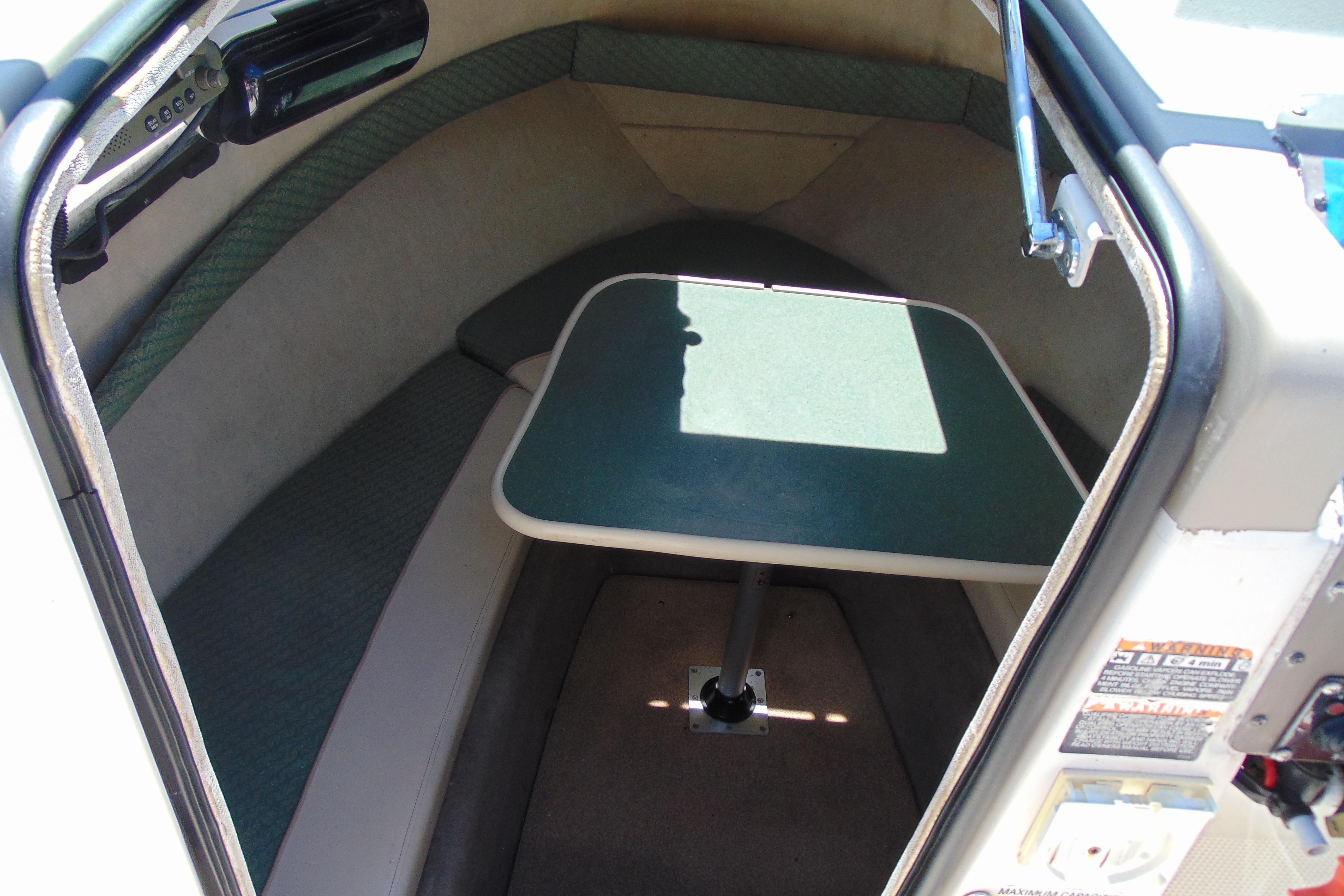 2002 Trophy Walkaround cabin interior with table and seating.