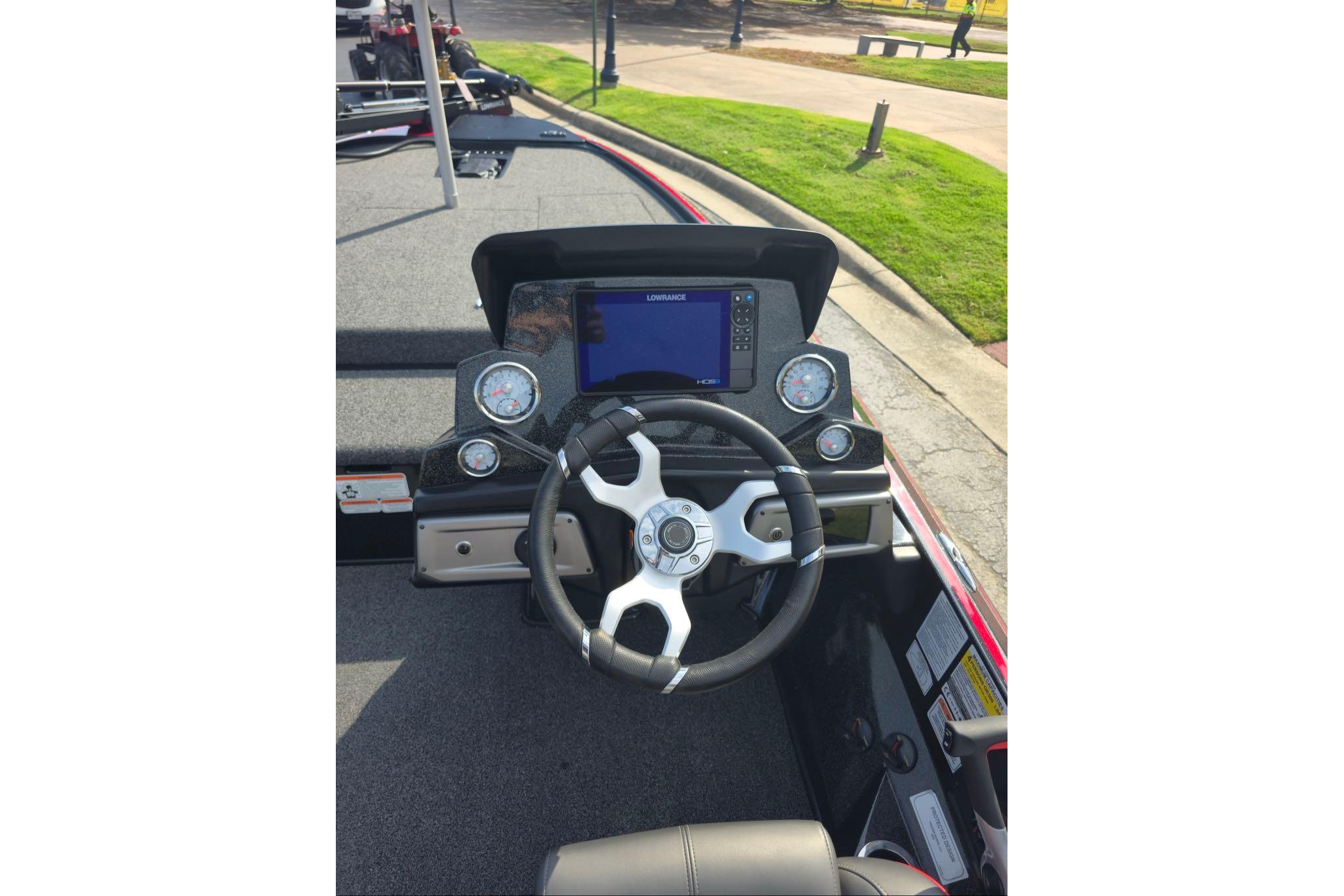 2024 Nitro Z19 boat dashboard with steering wheel and digital display.