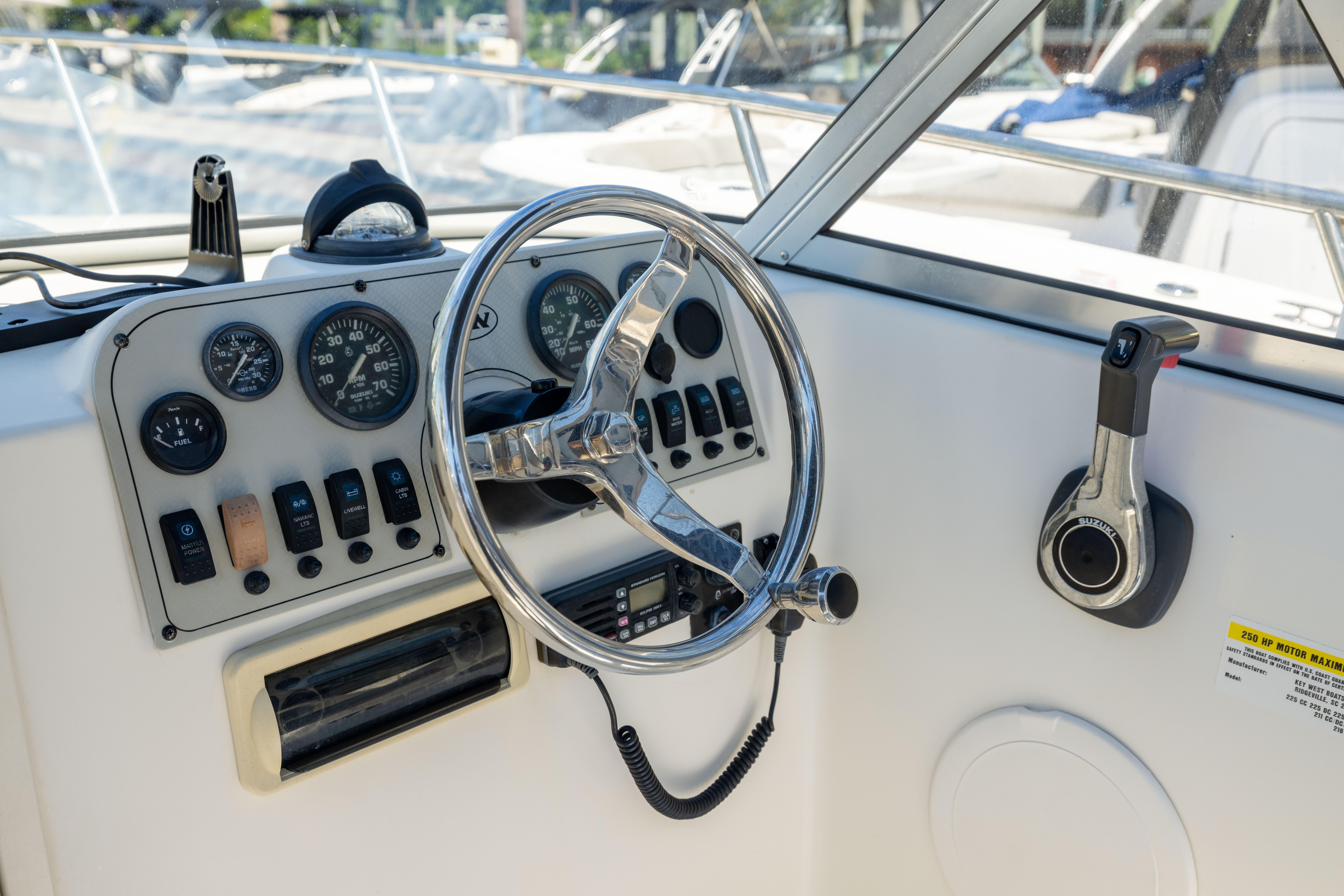 Steering console of a 2012 KEYWEST 2020 WA boat with gauges and controls.